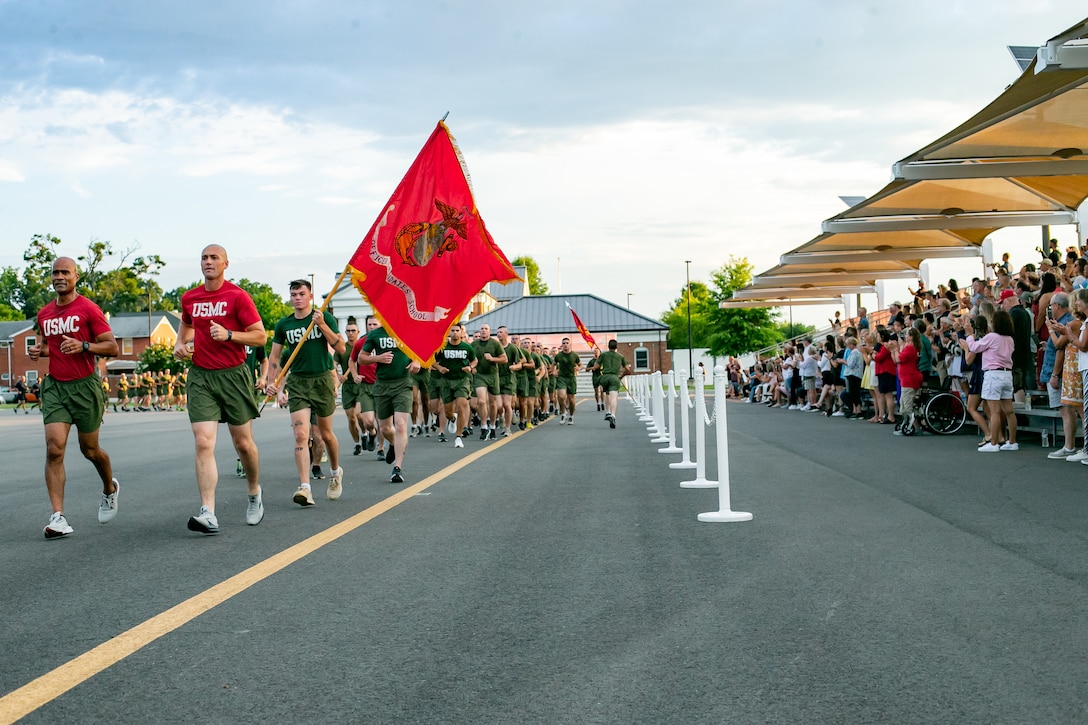 Candidates participate in the Battalion Commander's Motivational Run. The Motivational Run presents an opportunity for the candidates and training company staff to capitalize on the esprit de corps, teamwork, and camaraderie developed over the course of the training cycle. (U.S. Marine Corps photo by Sgt Gumchol Cho)