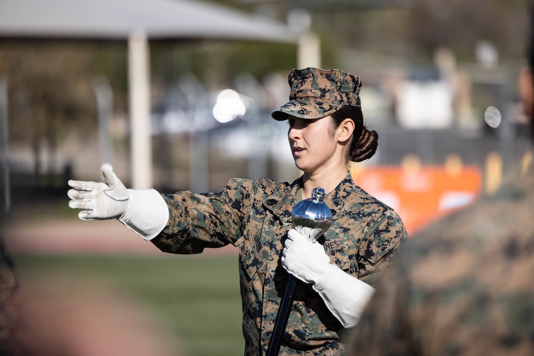 U.S. Marine Staff Sgt. Jessica Larsen, the 1st Marine Division Band drum major, instructs band members during rehearsal at Marine Corps Base Camp Pendleton, California, Jan. 24, 2023. Larsen’s first duty station was at the Blue Diamond as a lance corporal saxophone instrumentalist, and now after three years as a drill instructor, she has returned for a second tour. Larsen is a native of Saint Donatus, Iowa.  (U.S. Marine Corps photo by Cpl. Cameron Hermanet)