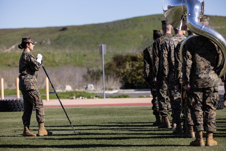 U.S. Marine Staff Sgt. Jessica Larsen, the 1st Marine Division Band drum major, instructs band members during rehearsal at Marine Corps Base Camp Pendleton, California, Jan. 24, 2023. Larsen’s first duty station was at the Blue Diamond as a lance corporal saxophone instrumentalist, and now after three years as a drill instructor, she has returned for a second tour. Larsen is a native of Saint Donatus, Iowa.  (U.S. Marine Corps photo by Cpl. Cameron Hermanet)