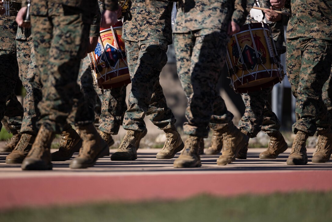 U.S. Marines with the 1st Marine Division Band practice drill at Marine Corps Base Camp Pendleton, California, Jan. 24, 2024. Practices and event rehearsals are led by Staff Sgt. Jessica Larsen, the drum major of the 1st MARDIV Band. Larsen’s first duty station was at the Blue Diamond as a lance corporal saxophone instrumentalist, and now after three years as a drill instructor, she has returned for a second tour. Larsen is a native of Saint Donatus, Iowa.  (U.S. Marine Corps photo by Cpl. Cameron Hermanet)