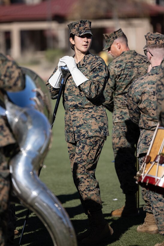 U.S. Marine Staff Sgt. Jessica Larsen, the 1st Marine Division Band drum major, instructs band members during rehearsal at Marine Corps Base Camp Pendleton, California, Jan. 24, 2023. Larsen’s first duty station was at the Blue Diamond as a lance corporal saxophone instrumentalist, and now after three years as a drill instructor, she has returned for a second tour. Larsen is a native of Saint Donatus, Iowa.  (U.S. Marine Corps photo by Cpl. Cameron Hermanet)