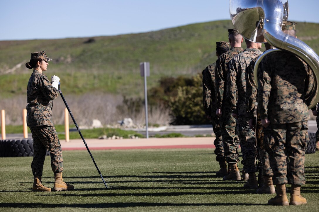 U.S. Marine Staff Sgt. Jessica Larsen, the 1st Marine Division Band drum major, instructs band members during rehearsal at Marine Corps Base Camp Pendleton, California, Jan. 24, 2023. Larsen’s first duty station was at the Blue Diamond as a lance corporal saxophone instrumentalist, and now after three years as a drill instructor, she has returned for a second tour. Larsen is a native of Saint Donatus, Iowa.  (U.S. Marine Corps photo by Cpl. Cameron Hermanet)