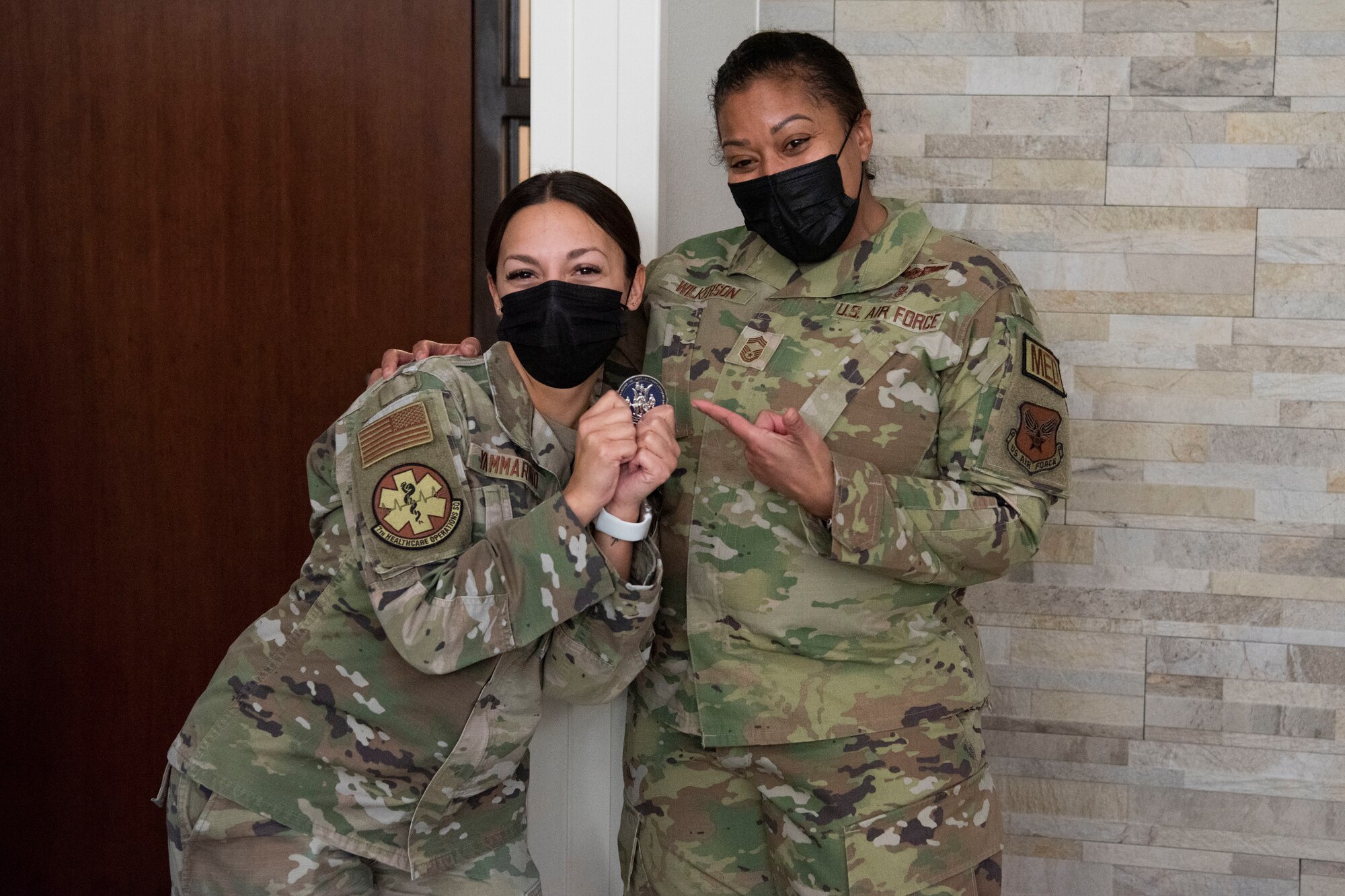 Chief Master Sgt. Taliah Wilkerson, Air Force Readiness Agency's Aerospace Medical Service and Surgical Service Career Field Manager, poses with Senior Airman Paige Yammarino, 7th Medical Group medical service flight allergy immunization technician, during her visit at Dyess Air Force Base, Texas, February 22, 2023. Brig. Gen. Jeannine Ryder, 59th Medical Wing commander and chief of the Air Force Nurse Corps, and Wilkerson provided a strategic overview and future posture of the Total Nursing Force at the 7th MDG, while also learning about the different mission sets by the Airmen. (U.S. Air Force photo by Airman 1st Class Alondra Cristobal Hernandez)