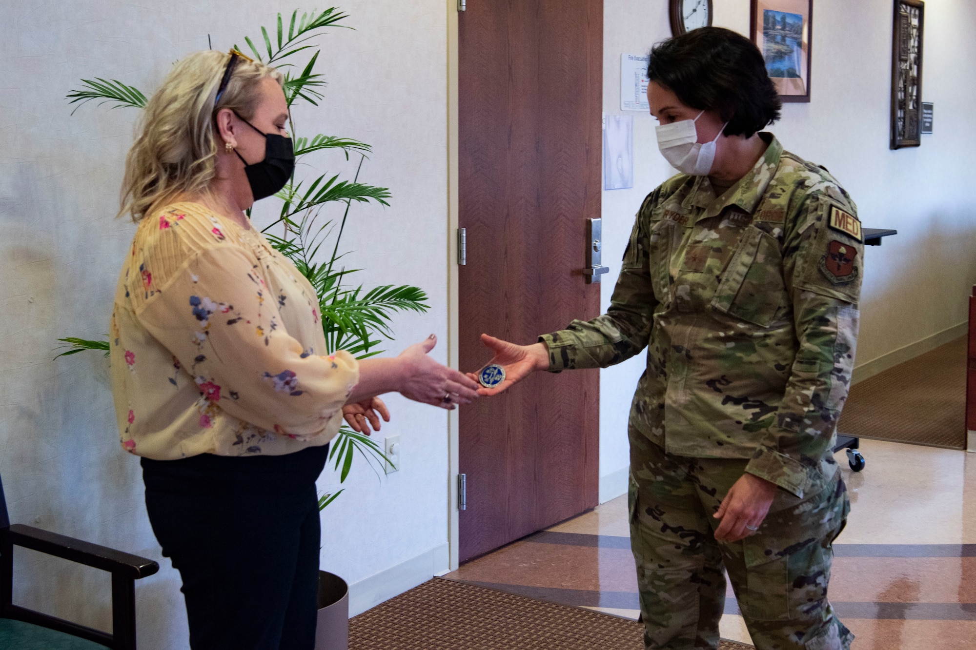 Brig. Gen. Jeannine Ryder, 59th Medical Wing commander and chief of the Air Force Nurse Corps, coins Lori Martin, 7th Operational Medical Readiness Squadron flight medicine nurse, at Dyess Air Force Base, Texas, February 22, 2023. Ryder and Chief Master Sgt. Taliah Wilkerson, Air Force Readiness Agency's Aerospace Medical Service and Surgical Service Career Field Manager, provided a strategic overview and future posture of the Total Nursing Force at the 7th Medical Group, while also learning about the different mission sets by the Airmen. (U.S. Air Force photo by Airman 1st Class Alondra Cristobal Hernandez)