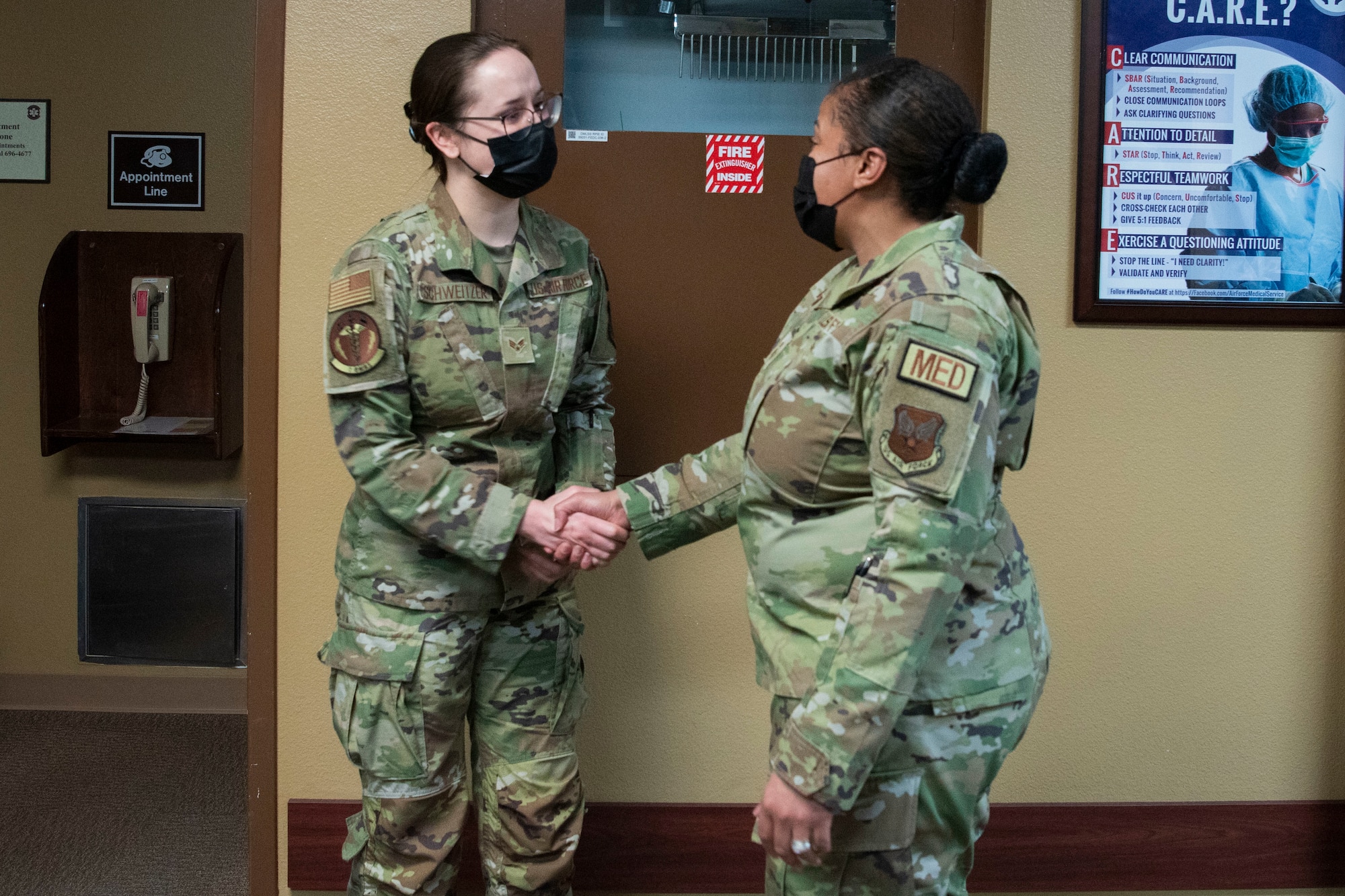 Chief Master Sgt. Taliah Wilkerson, Air Force Readiness Agency's Aerospace Medical Service and Surgical Service Career Field Manager, coins Senior Airman Kaitlyn Schweitzer, 7th Medical Group warrior clinic technician, during her visit at Dyess Air Force Base, Texas, February 22, 2023. Brig. Gen. Jeannine Ryder, 59th Medical Wing commander and chief of the Air Force Nurse Corps, and Wilkerson provided a strategic overview and future posture of the Total Nursing Force at the 7th MDG, while also learning about the different mission sets by the Airmen. (U.S. Air Force photo by Airman 1st Class Alondra Cristobal Hernandez)