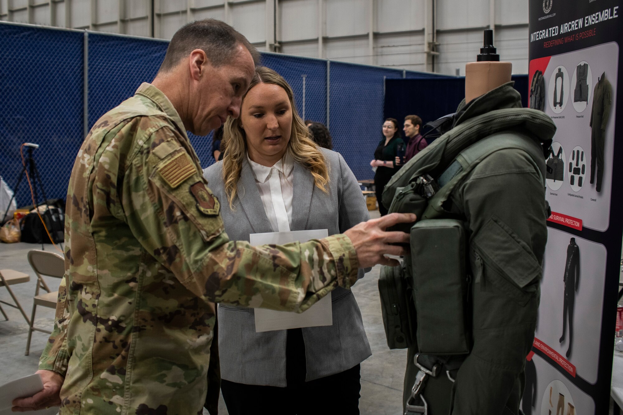 AFLCMC  Commander Lt. Gen. Shaun Q. Morris looks at a female aircrew ensemble during the 2022 Sword Athena event at Langley, Va. (USAF photo / Jim Varhegyi)