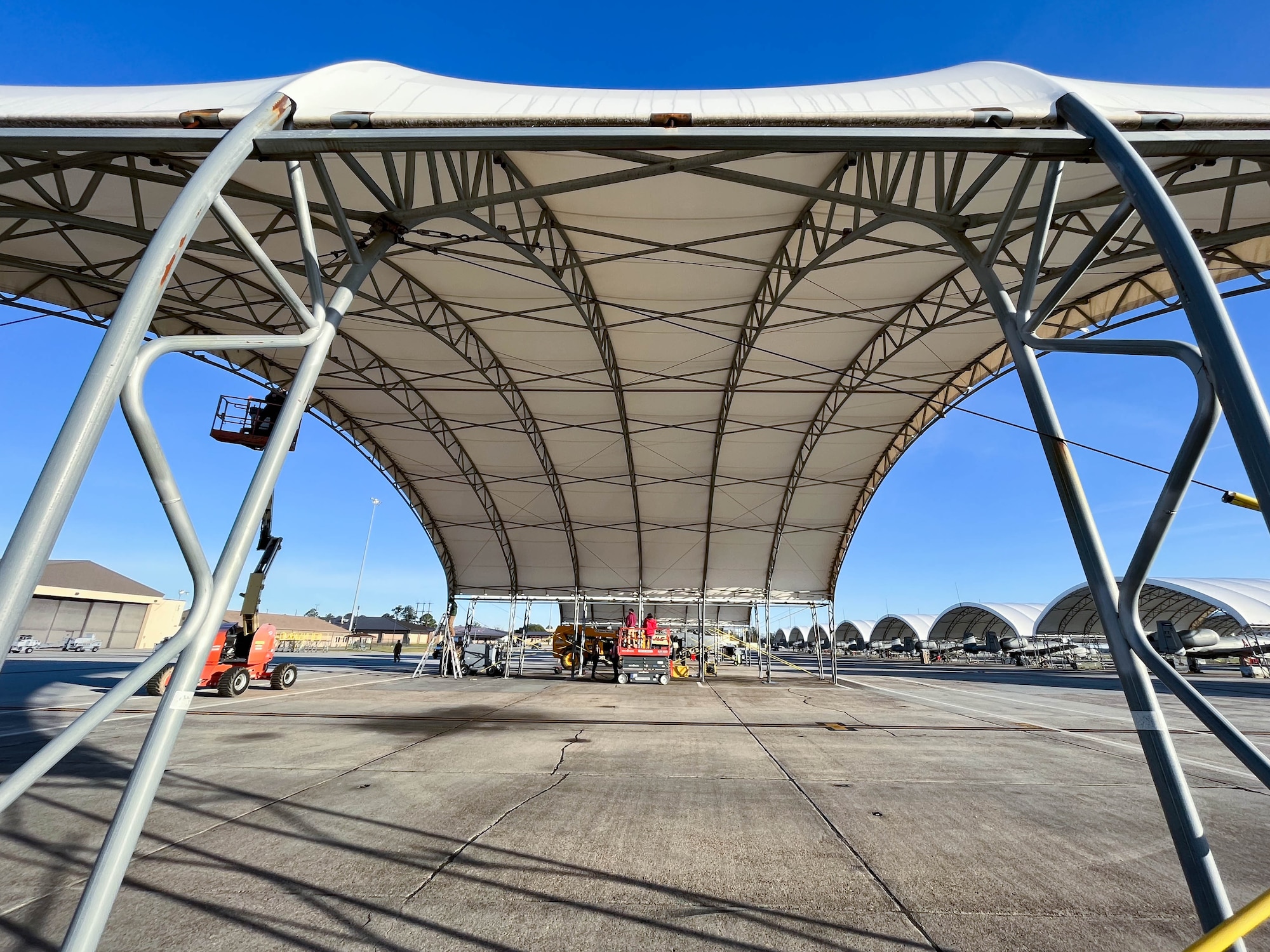 Members from Creative Tent International and Ryzing Technologies evaluate the A-10C Thunderbolt II sunshades at Moody Air Force Base, Georgia, Feb. 14, 2023. These sunshades have a lifespan of 10 years, and wear and tear from constant sun and inclement weather cause irreparable damage to the material. (U.S. Air Force courtesy photo)