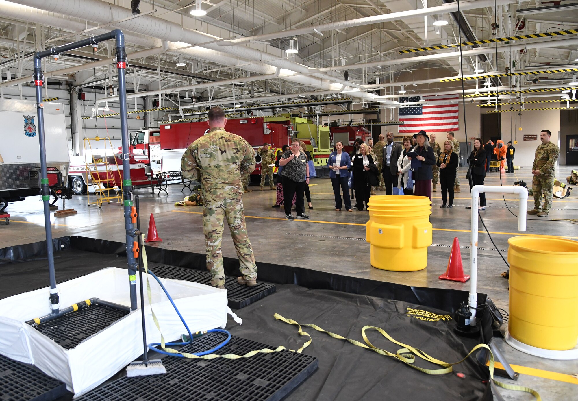 U.S. Air Force Master Sgt. Timothy McCutcheon, 81st Civil Engineer Squadron chief of operations assistant, provides a tour of the fire department bay to honorary commanders and civic leaders at Keesler Air Force Base, Mississippi, Feb. 17, 2023.