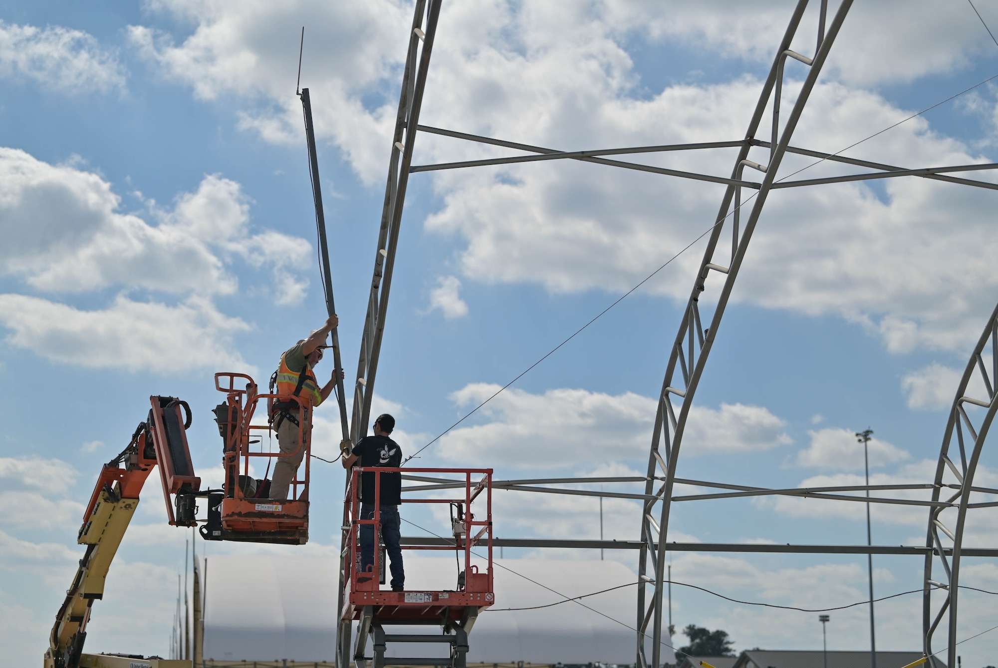 Members from Ryzing Technologies replaces a lightning rod pole on the A-10C Thunderbolt II sunshade structure at Moody Air Force Base, Georgia, Feb. 16, 2023. Once the bulk revamp process is started, it will take approximately one day to completely uninstall, clean the metal hardware and install an entire new singular sunshade. (U.S. Air Force photo by Senior Airman Rebeckah Medeiros)