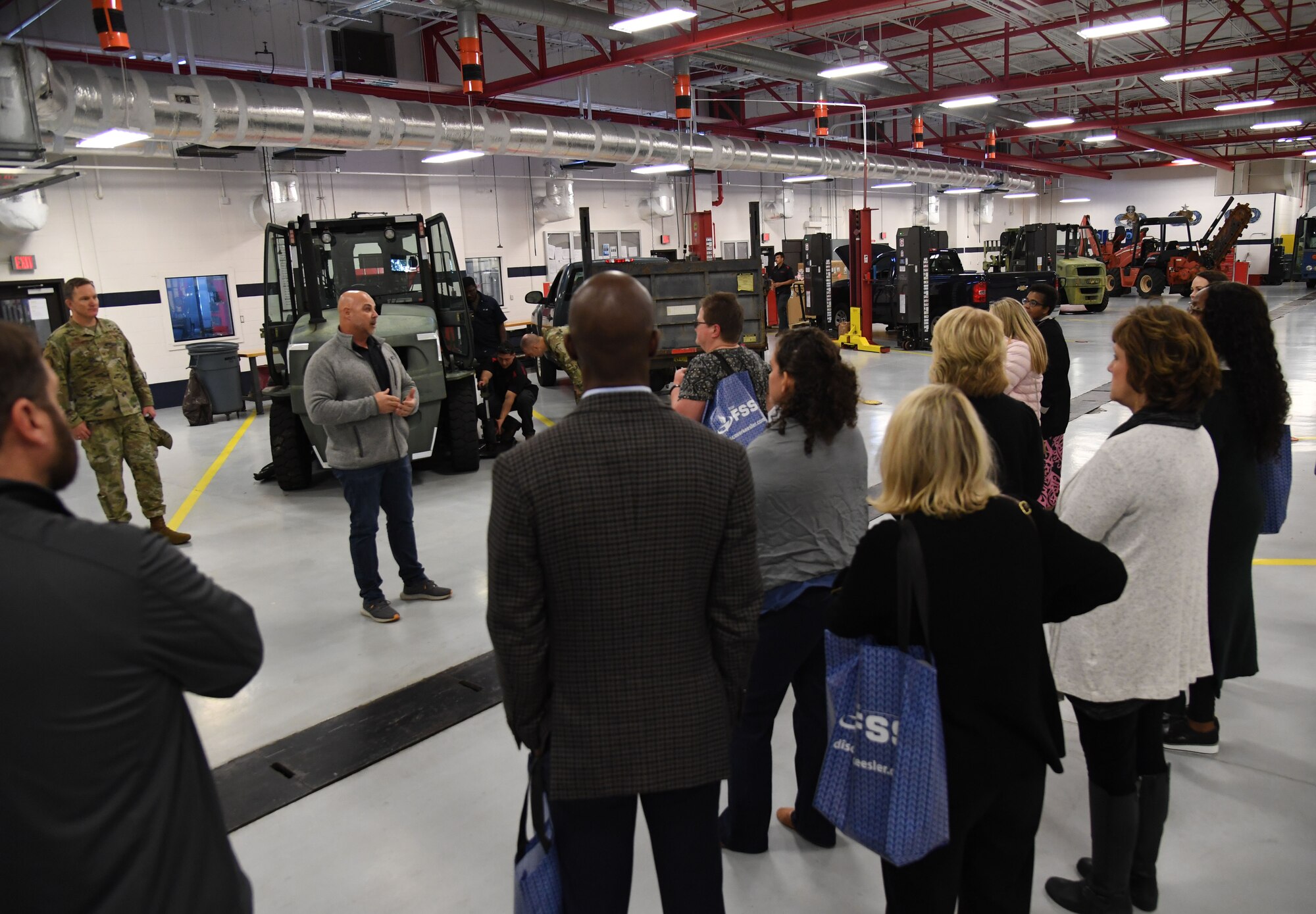 Timothy Gray, 81st Logistics Readiness Squadron vehicle management flight chief, provides a tour inside the vehicle maintenance facility to honorary commanders and civic leaders at Keesler Air Force Base, Mississippi, Feb. 17, 2023.