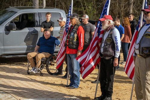 Veterans stand out side with the American flag