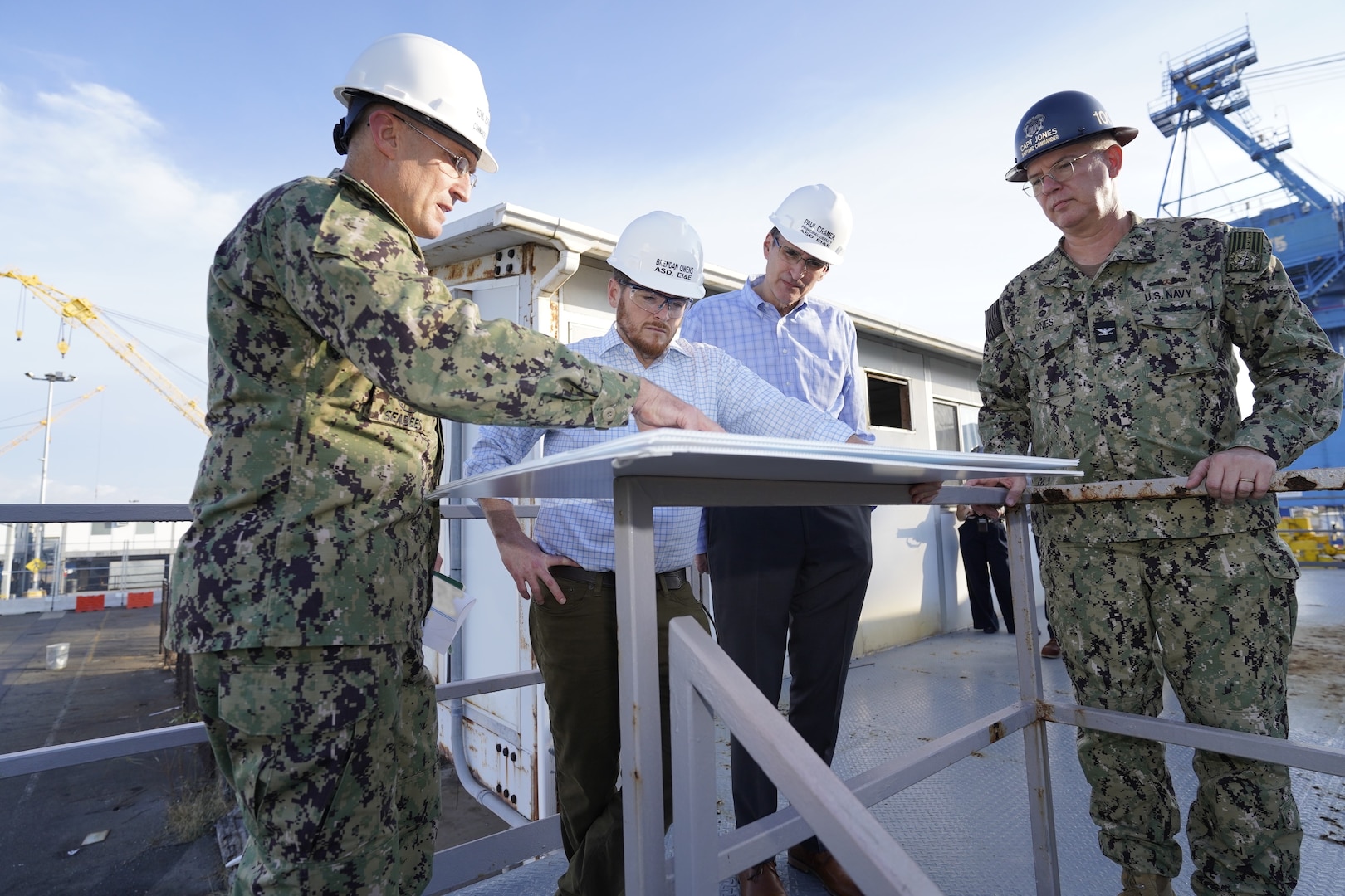 Rear Adm. Jeffrey J. Kilian (left), the commander of Naval Facilities Engineering Systems Command Pacific/Director, Fleet Civil Engineer, U.S. Pacific Fleet, briefs Brendan Owens, the assistant secretary of defense for energy, installations, and environment (ASD EI&E) and Paul D. Cramer, the principal deputy of ASD EI&E, during their visit to Pearl Harbor Naval Shipyard and Intermediate Maintenance Facility (PHNSY & IMF), Feb. 1, 2023.

During the visit, Owens and Cramer met with senior leadership from PHNSY & IMF to assess progress on the Navy’s Shipyard Infrastructure Optimization Program and tour the shipyard’s dry dock areas that will be modernized beginning in 2023. The first modernization action proposes to construct and operate a new graving dry dock and waterfront production facility to support current and future classes of the nation’s nuclear-powered submarines.