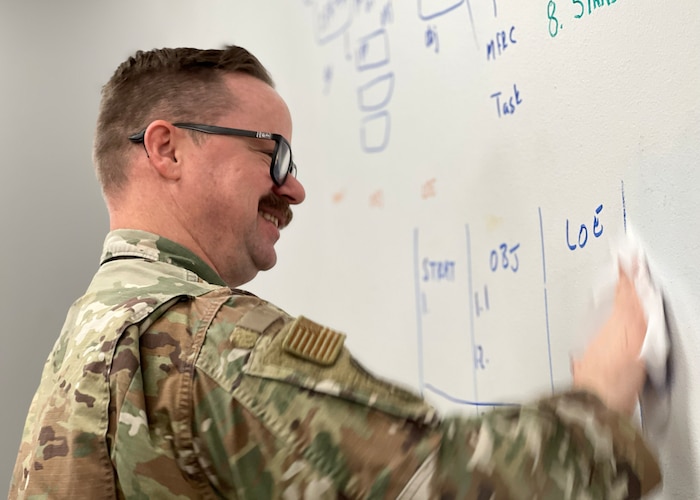 U.S. Air Force Tech. Sgt. Justin Crook, 17th Training Wing Raider Spark Cell section chief, cleans a dry erase board, Goodfellow Air Force Base, Texas, Feb. 15, 2023. The 17th TRW RSC was a physical and opportunistic location designed to accelerate change by transforming service members’ ideas into workplace realities. (U.S. Air Force photo by Staff Sgt. Abbey Rieves)