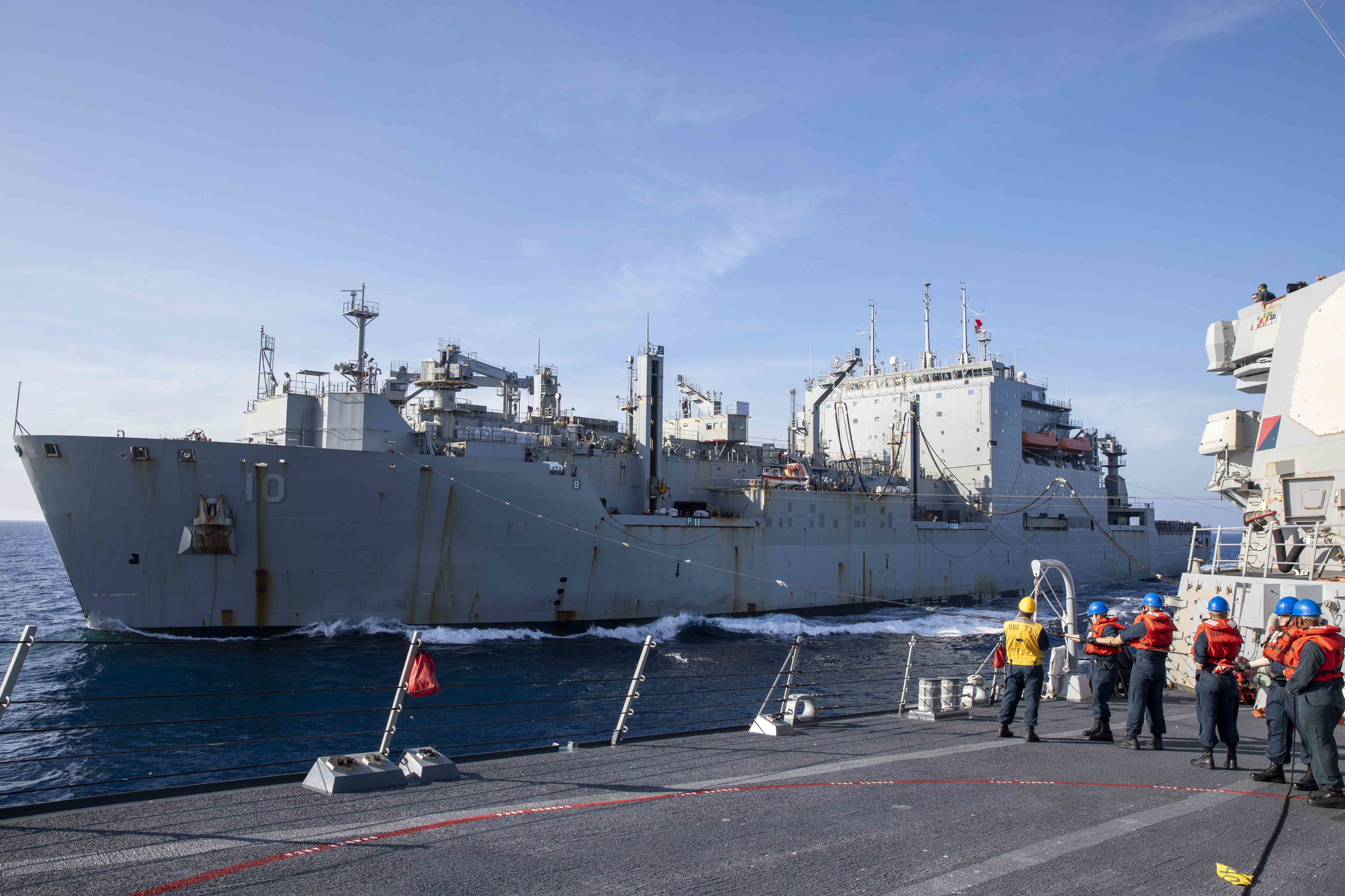 U.S. Navy Sailors heave the phone and distance line during a replenishment-at-sea (RAS) with the Military Sealift Command fleet dry cargo and ammunition ship USNS Charles Drew (T-AKE 10) aboard the Arleigh Burke-class guided-missile destroyer USS Decatur (DDG 73).