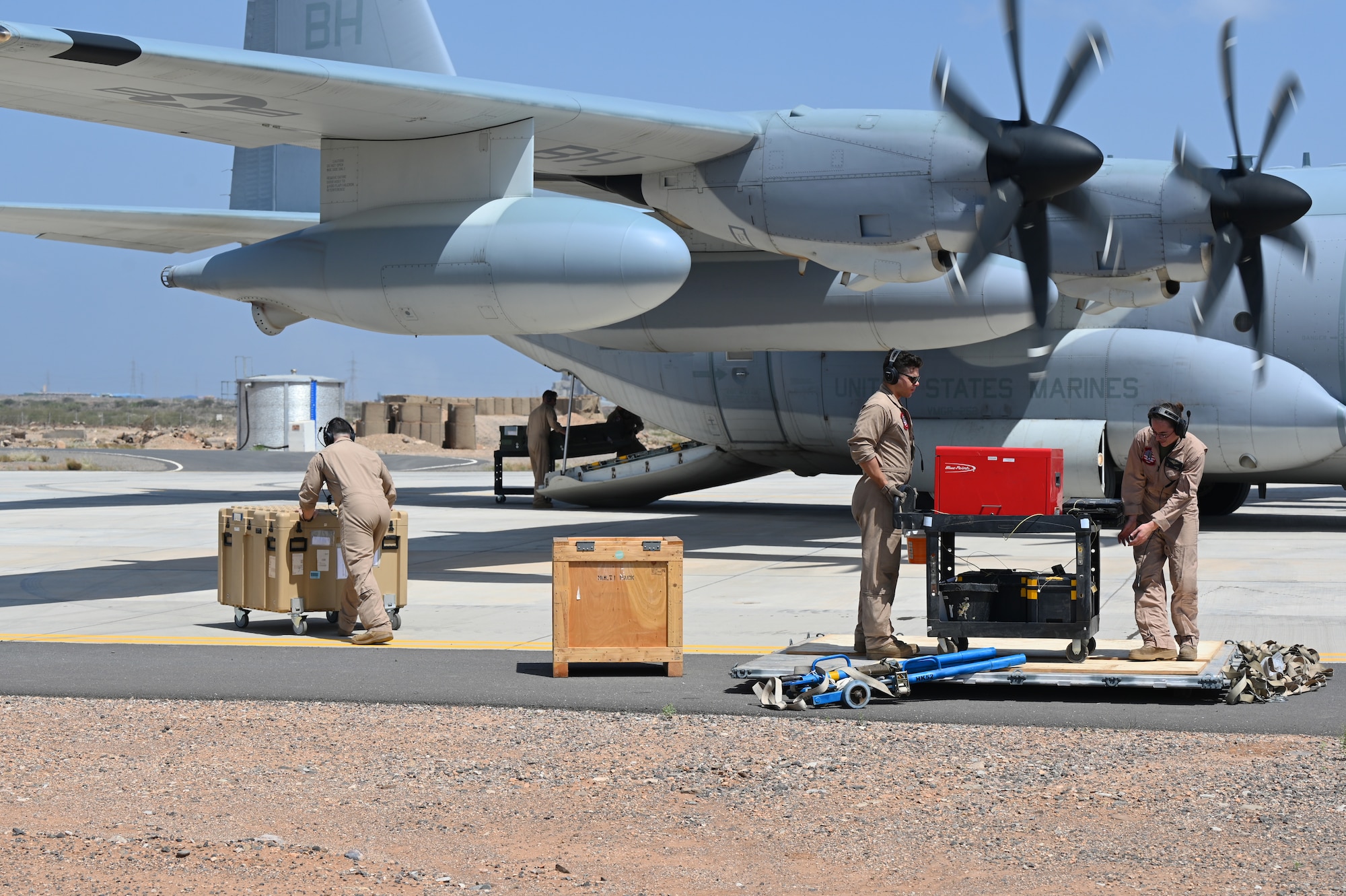 U.S. Marine Corps KC-130 crew members load supplies in support of a simulated Forward Arming and Refueling Point (FARP) exercise at Chabelley Airfield, Djibouti, Feb. 22, 2023. The FARP mission makes it possible to quickly refuel and rearm because aircraft supporting combat operations can refuel much closer to their area of operation, saving a significant amount of time. (U.S. Air Force photo by Tech. Sgt. Jayson Burns)
