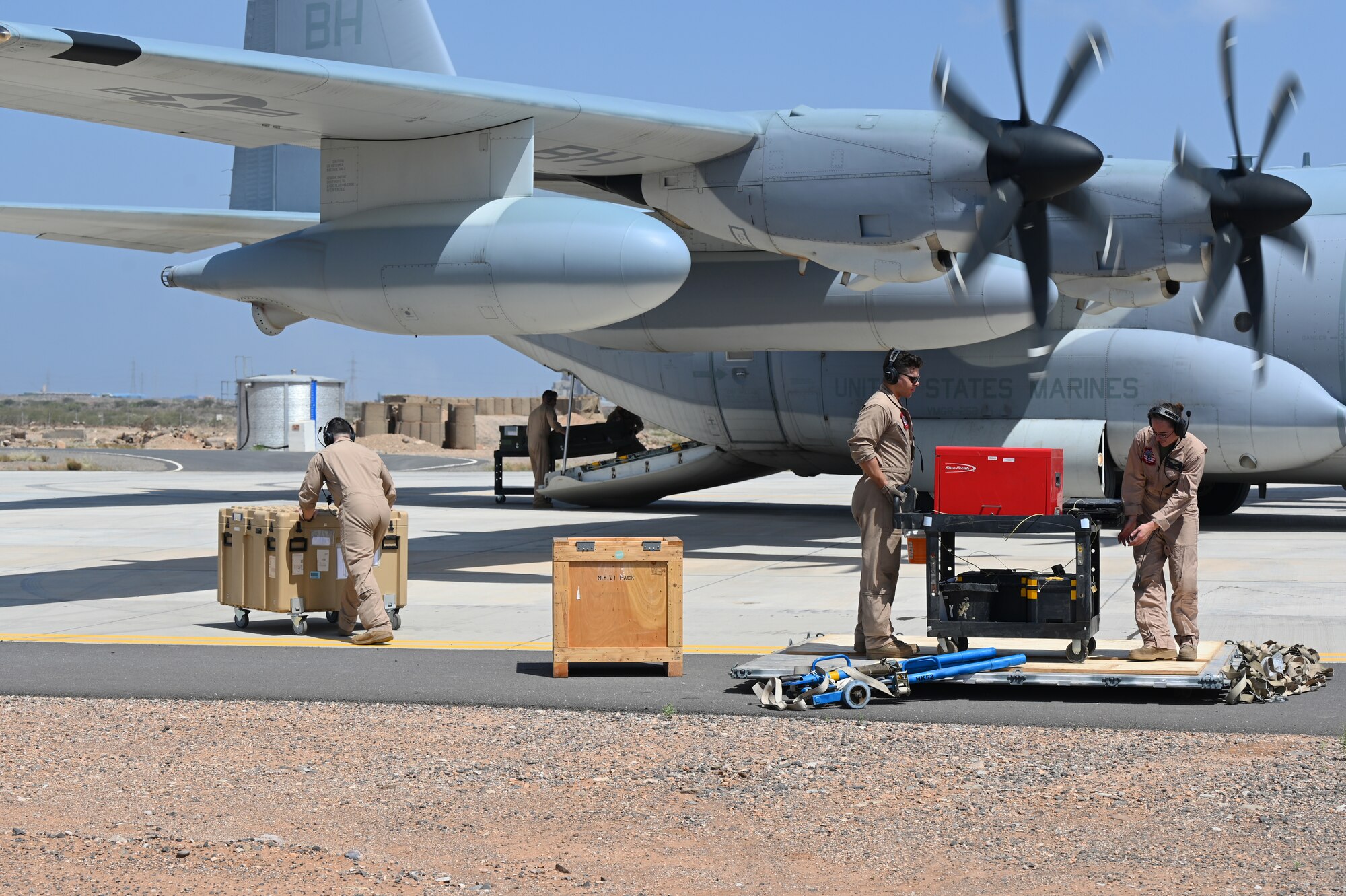 U.S. Marine Corps KC-130 crew members load supplies in support of a simulated Forward Arming and Refueling Point (FARP) exercise at Chabelley Airfield, Djibouti, Feb. 22, 2023. The FARP mission makes it possible to quickly refuel and rearm because aircraft supporting combat operations can refuel much closer to their area of operation, saving a significant amount of time. (U.S. Air Force photo by Tech. Sgt. Jayson Burns)