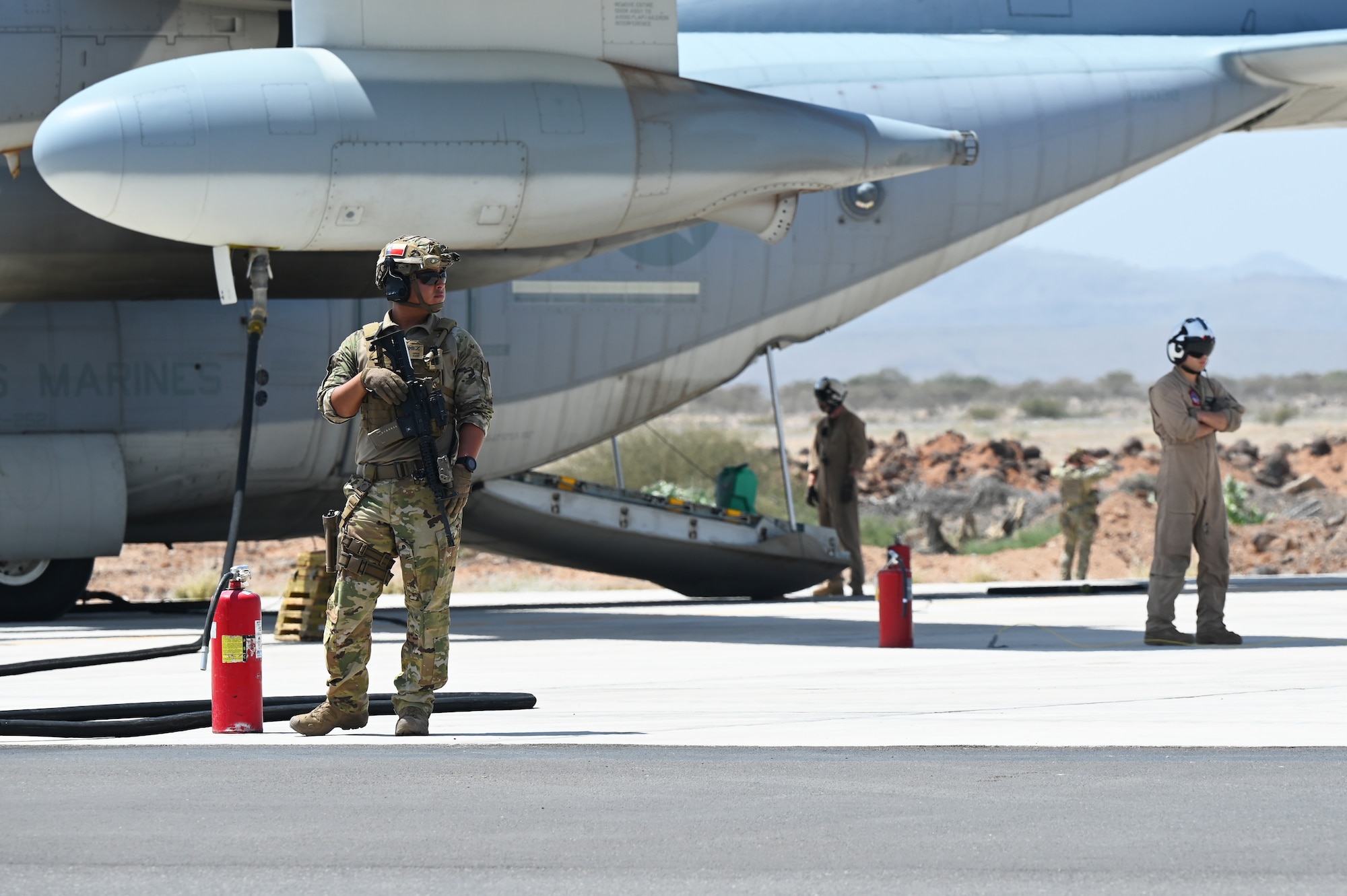 U.S. Army security personnel organize a perimeter around a KC-130 as its U.S. Marine Corps crew members unload supplies in support of a simulated Forward Arming and Refueling Point (FARP) exercise at Chabelley Airfield, Djibouti, Feb. 22, 2023. The ability of a Joint Force Commander to move their forces fluidly across the theater to seize, retain and utilize initiatives against an adversary is key to ensuring readiness and resilience, and protecting assets and personnel. (U.S. Air Force photo by Tech. Sgt. Jayson Burns)
