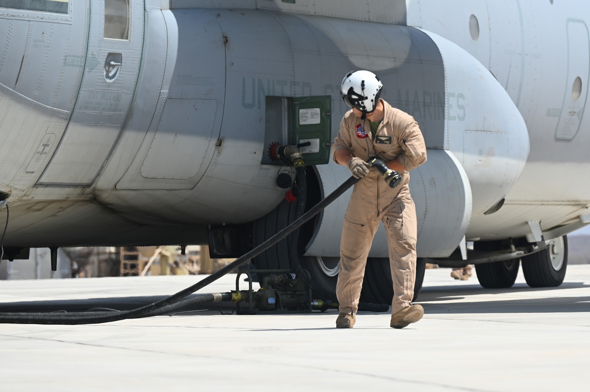 A U.S. Marine Corps KC-130 crew member prepares to conduct a refueling operation in support of a simulated Forward Arming and Refueling Point (FARP) exercise at Chabelley Airfield, Djibouti, Feb. 22, 2023. The FARP mission makes it possible to quickly refuel and rearm because aircraft supporting combat operations can refuel much closer to their area of operation, saving a significant amount of time. (U.S. Air Force photo by Tech. Sgt. Jayson Burns)