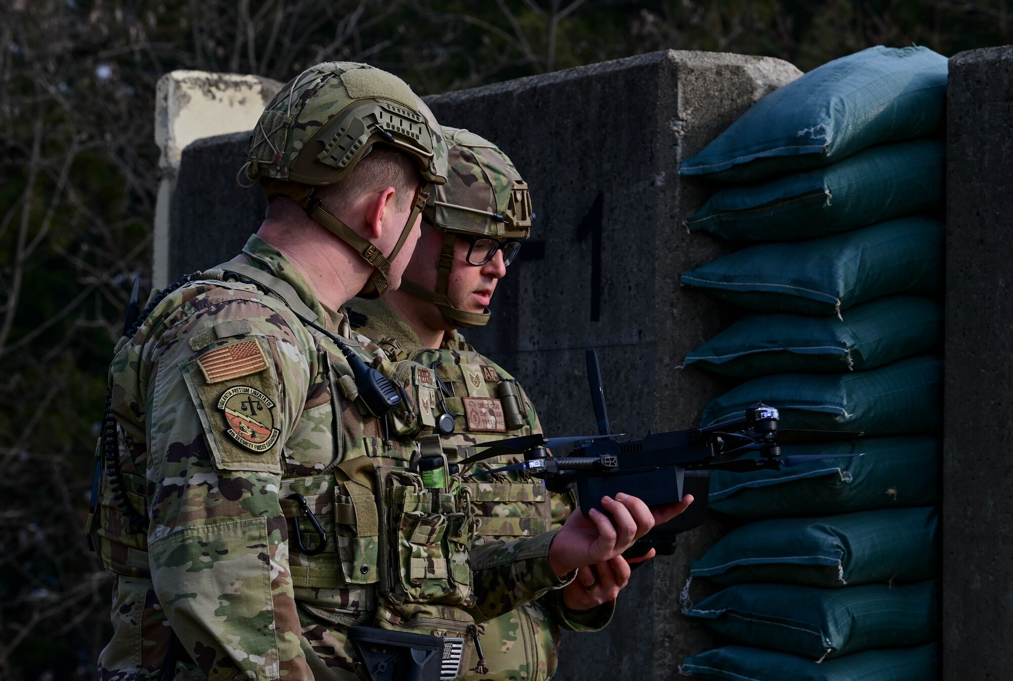 Staff Sgt. Zackery Freiberg, 8th Security Forces Squadron defender, and Staff Sgt. Carlos Casas, 8th SFS small, unmanned aircraft system (sUAS) operator, prepares a sUAS during the Wolf Leadership Forum, at Kunsan Air Base, Republic of Korea, Feb. 23, 2023. The sUAS keeps personnel safe during the reconnaissance process of missions. (U.S. Air Force photo by Senior Airman Shannon Braaten)