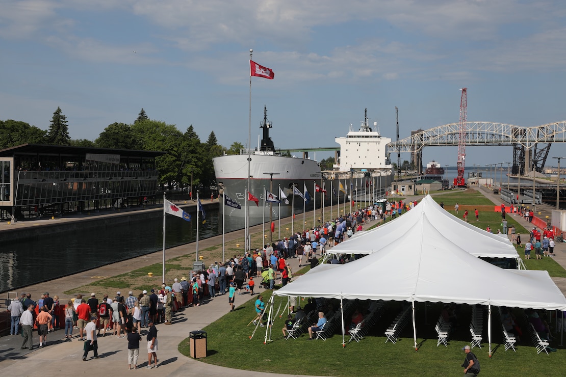 Soo Locks Engineers Day visitors line the north wall of the MacArthur Lock as the Kaministiqua heads downbound in the MacArthur Lock at the Soo Locks, in Sault Ste. Marie, Mich. on June 24, 2022.