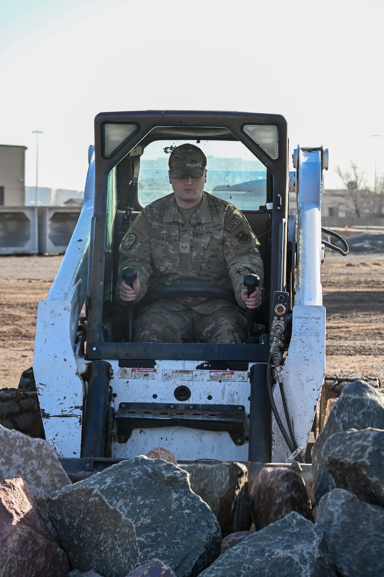 U.S. Air Force Senior Airman John Mason, 97th Civil Engineer Squadron pavement and equipment operator journeyman, operates heavy machinery at Altus Air Force Base, Oklahoma, Feb. 15, 2023. Dirt boyz are a team of Airmen who take care of the base from building flood gates to paving new roads. (U.S. Air Force photo by Senior Airman Kayla Christenson)
