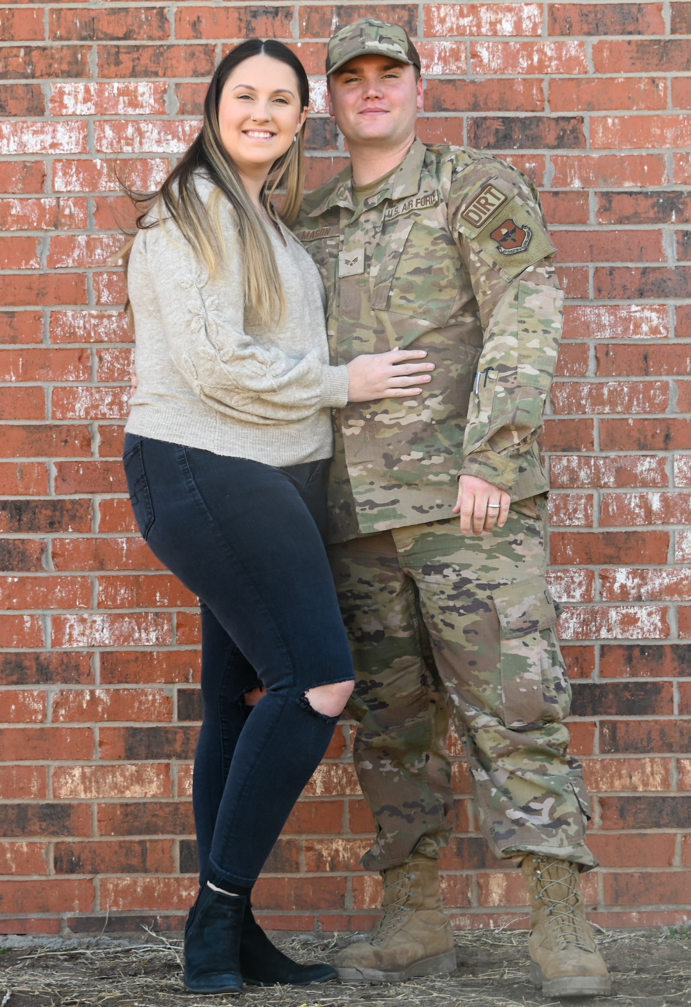 U.S. Air Force Senior Airman John Mason, 97th Civil Engineer Squadron pavement and equipment operator journeyman, and his wife, Sadiee, pose for a photo at Altus Air Force Base, Oklahoma, Feb. 15, 2023. Mason and Sadiee have been together for a year. (U.S. Air Force photo by Senior Airman Kayla Christenson)
