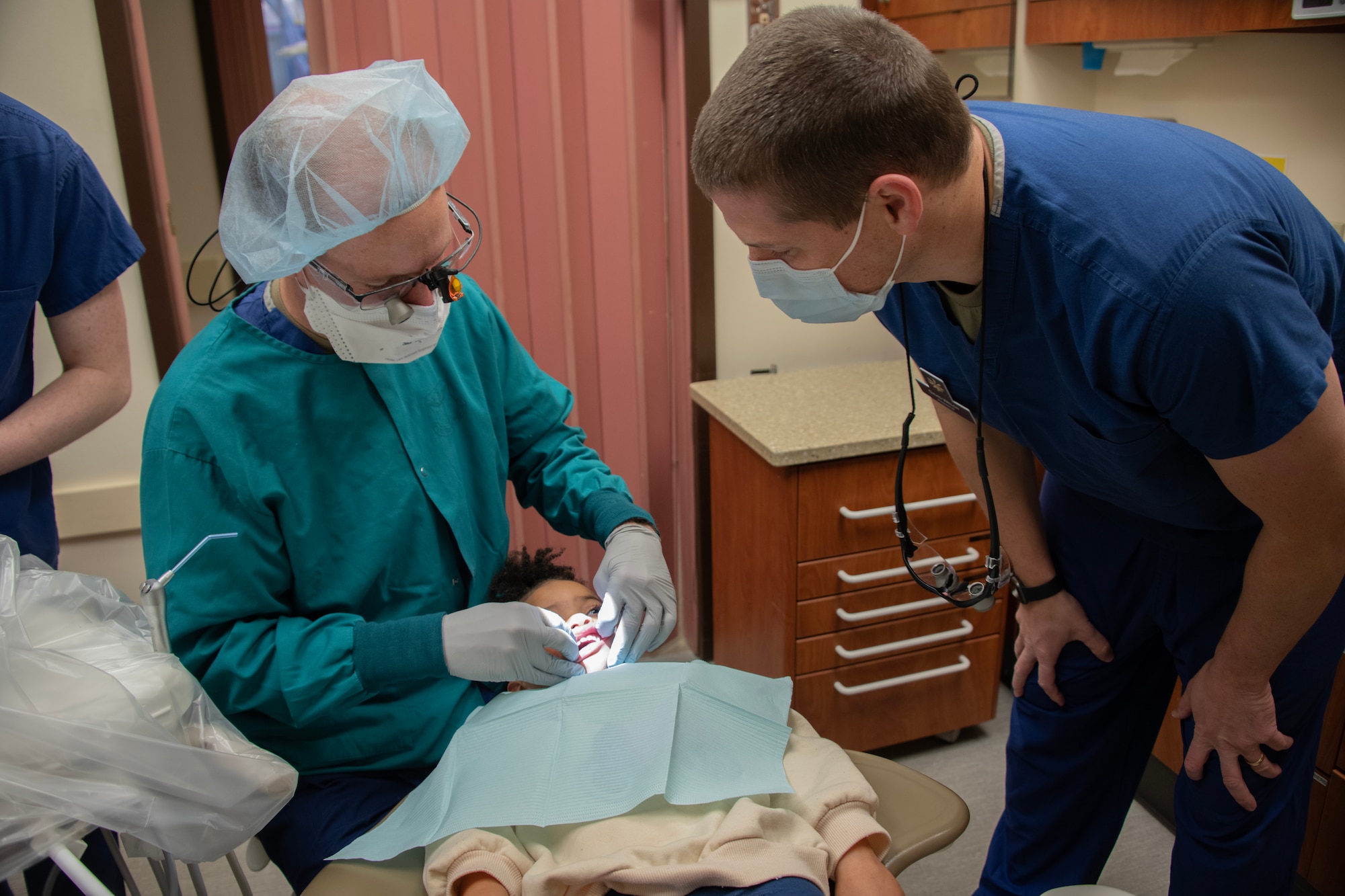 Dentists examine child