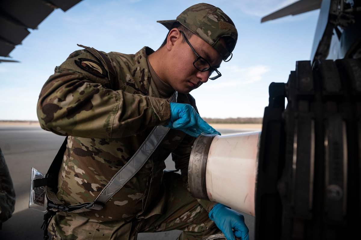 Airman 1st Class Byron Sequeira, 436th Aircraft Maintenance Squadron crew chief, applies lubricant to a C-5M Super Galaxy wheel axle on Dover Air Force Base, Delaware, Feb. 15, 2023. The creation of the 436th Mission Generation Group includes the 436th Logistics Readiness Squadron to better support maintenance squadrons and realign unit priorities under a mission generation culture. (U.S. Air Force photo by Staff Sgt. Marco A. Gomez)