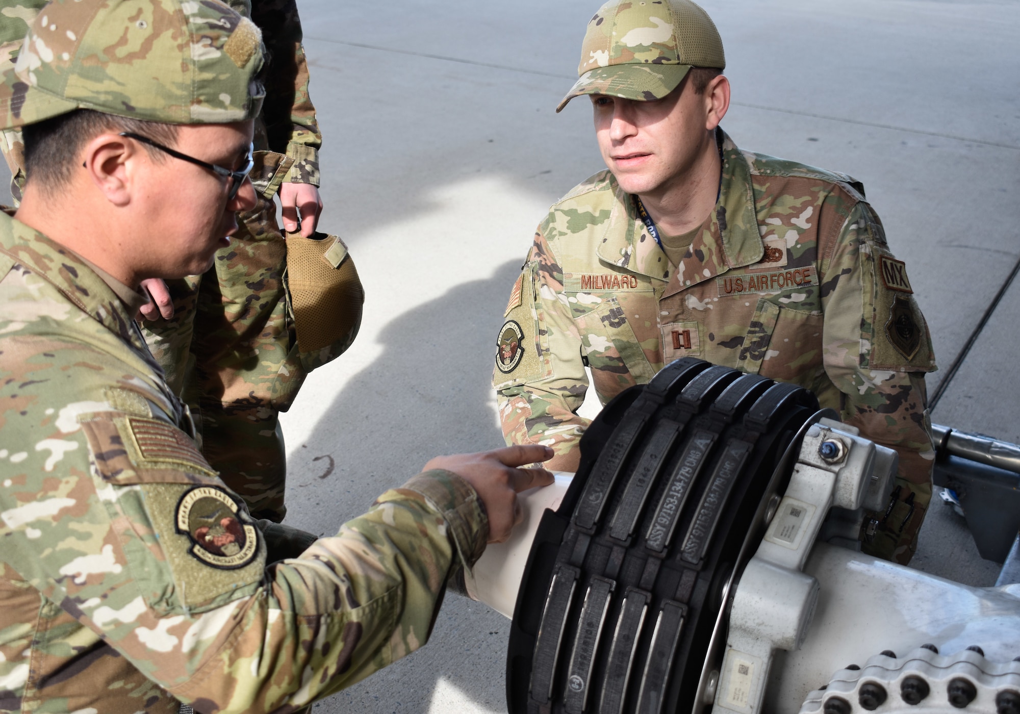 Capt. Patrick Milward, 436th Aircraft Maintenance Squadron operations officer, discusses a C-5M Super Galaxy tire change with Airman 1st Class Byron Sequeira, 436th AMXS crew chief, on Dover Air Force Base, Delaware, Feb. 15, 2023. The creation of the 436th Mission Generation Group includes the 436th Logistics Readiness Squadron to better support maintenance squadrons and realign unit priorities under a mission generation culture. (U.S. Air Force photo by 2nd Lt. Jackie Noffsinger)