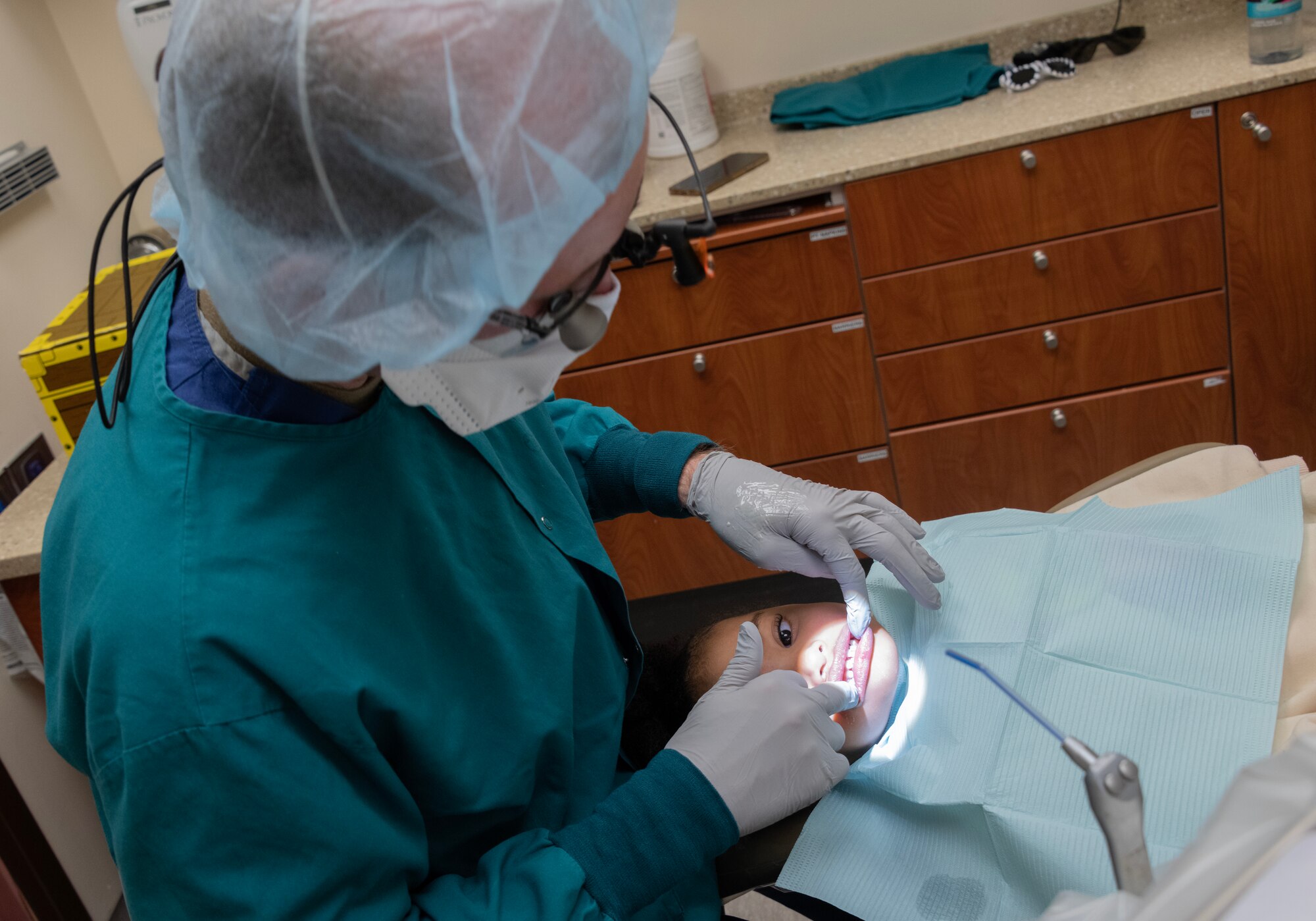 Dentist examines child