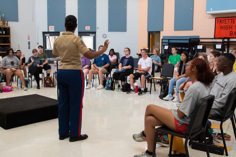 U.S. Marine Staff Sgt. Mardia Timoney, the Musician Technical Assistant for 6th Marine Corps District, speaks to band students at Fayette County High School in Fayette, Alabama, July 25, 2022. Timoney spoke with the students about what being a Marine musician is like and how they can audition to become one. (U.S. Marine Corps photo by Sgt. Shannon Doherty)
