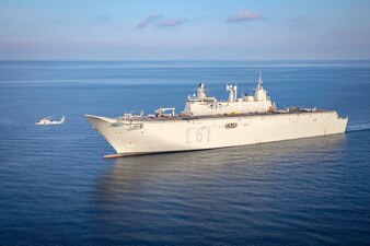 An MH-60S Sea Hawk helicopter from HSC-5 and two Spanish navy SH-60B helicopters fly near the Spanish navy ship ESPS Juan Carlos I (LHD 61) during interoperability training in the Adriatic Sea.