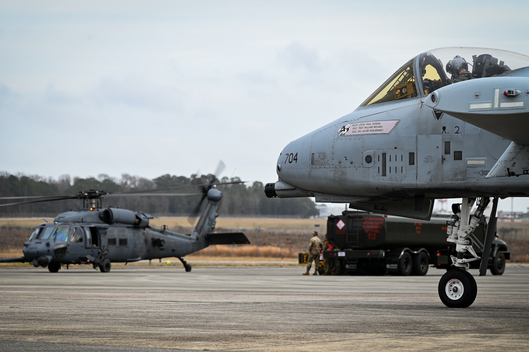 A U.S. Air Force A-10C Thunderbolt II from the 175th Wing, Maryland Air National Guard, taxis past a HH-60G Pave Hawk being refueled at Hunter Army Airfield, Georgia, Jan 25, 2023 during exercise Sunshine Rescue, hosted by the Savannah Combat Readiness Training Center.