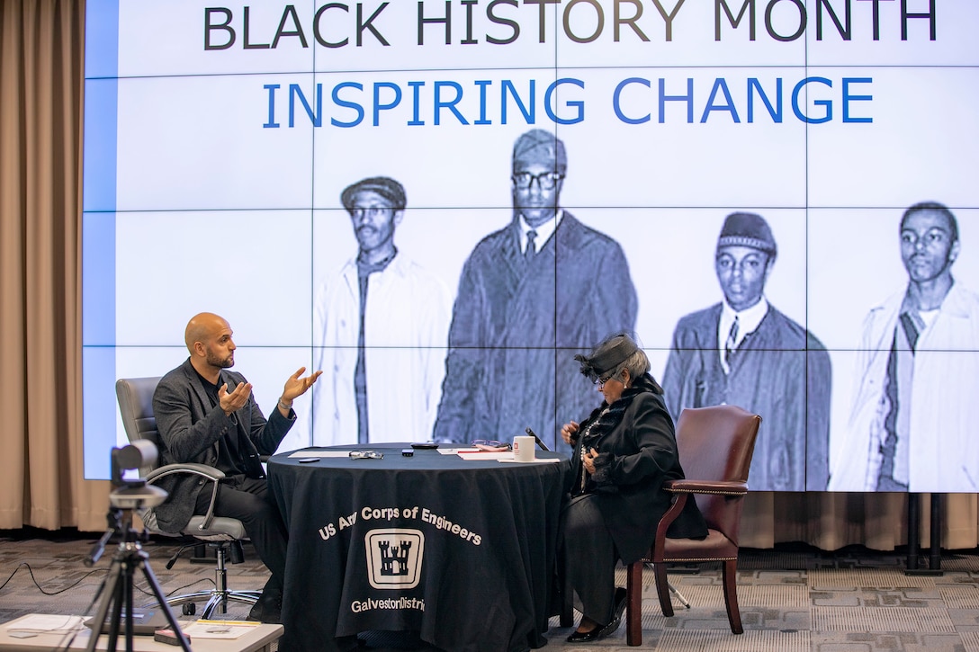 Deputy Public Affairs Officer for U.S. Army Corps of Engineers Galveston District Carlos Gomez interviews “Momma Shug,” a character—said to be more than 100 years old—played by district Executive Office Administrative Support Assistant Pat Agee, during the district’s Black History Month observance.