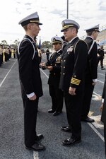 Capt. Stephen Audelo, right, Naval Education and Training Command’s (NETC) executive assistant, inspects Navy Junior Reserve Officers Training Corps students during an inspection at Booker T. Washington High School in Pensacola, Florida, Feb. 15, 2023. NETC's mission is to recruit, train and deliver those who serve our nation, taking them from street-to-fleet by transforming civilians into highly skilled, operational and combat ready warfighters. (United States Navy photo by Mass Communication Specialist 2nd Class Zachary Melvin)
