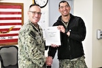 Southwest Regional Maintenance Center (SWRMC) Commanding Officer Capt. John Bauer (left) congratulates Cmdr. Ashley Wright Jan. 6 on his announcement on selection to receive the 2023 Federal Engineer of the Year Award