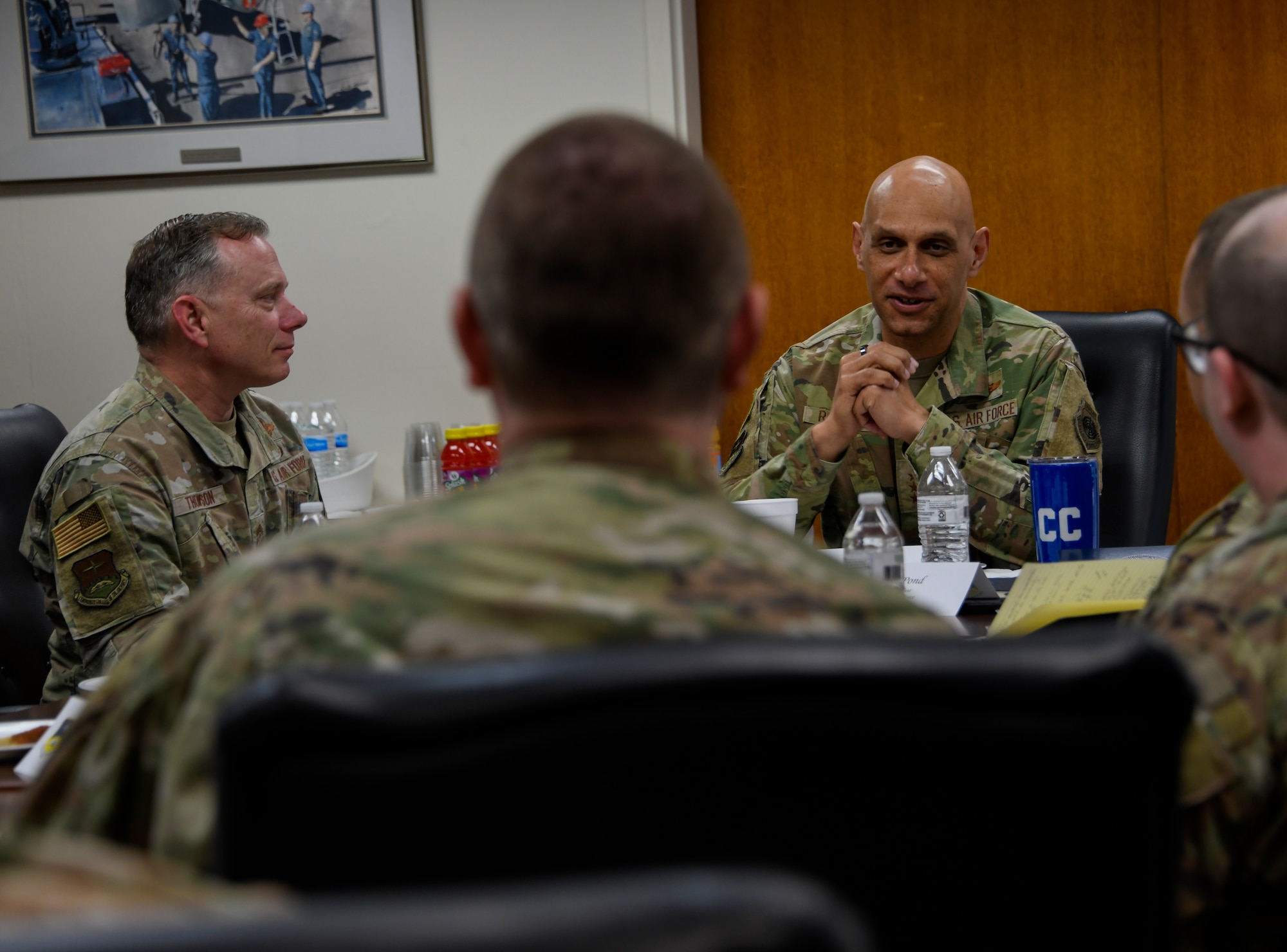 Lt. Gen. Brian Robinson and Chief Master Sgt. Erik Thompson, commander and command chief for Air Education and Training Command, listen as Tech. Sgt. Tate Young briefs the Community College of the Air Force's credentialing programs during the command team's visit to Maxwell Air Force Base, Alabama, Feb. 23, 2023. (U.S. Air Force photo by Brian Ferguson