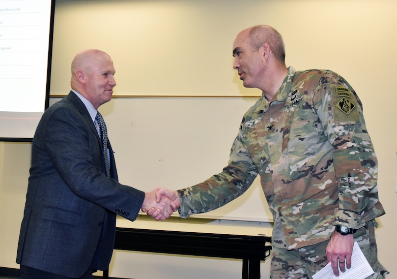 Col. Sebastien P. Joly, Huntsville Center commander, thanks Jeff Ogden, vice president of the Society of American Military Engineers Huntsville post, for speaking to employees during the Center's National Engineers Week presentation. (Photo by Kristen Bergeson)