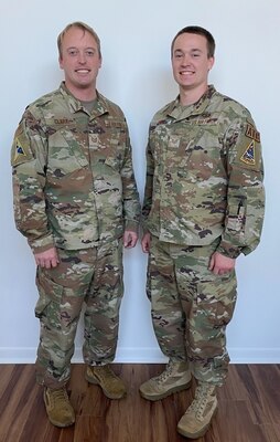 U.S. Air Force Tech. Sgt. David Clark, Space Launch Delta 45 Legal non-commissioned officer in charge of inspections and training readiness, and U.S. Air Force Staff Sgt. Michael Clark, 45th Launch Readiness Squadron air traffic controller pose for a photo at Patrick Space Force Base, Fla. Dec. 15, 2022. David Clark and Michael Clark are brothers who have been stationed at Patrick SFB together. (Courtesy Photo)