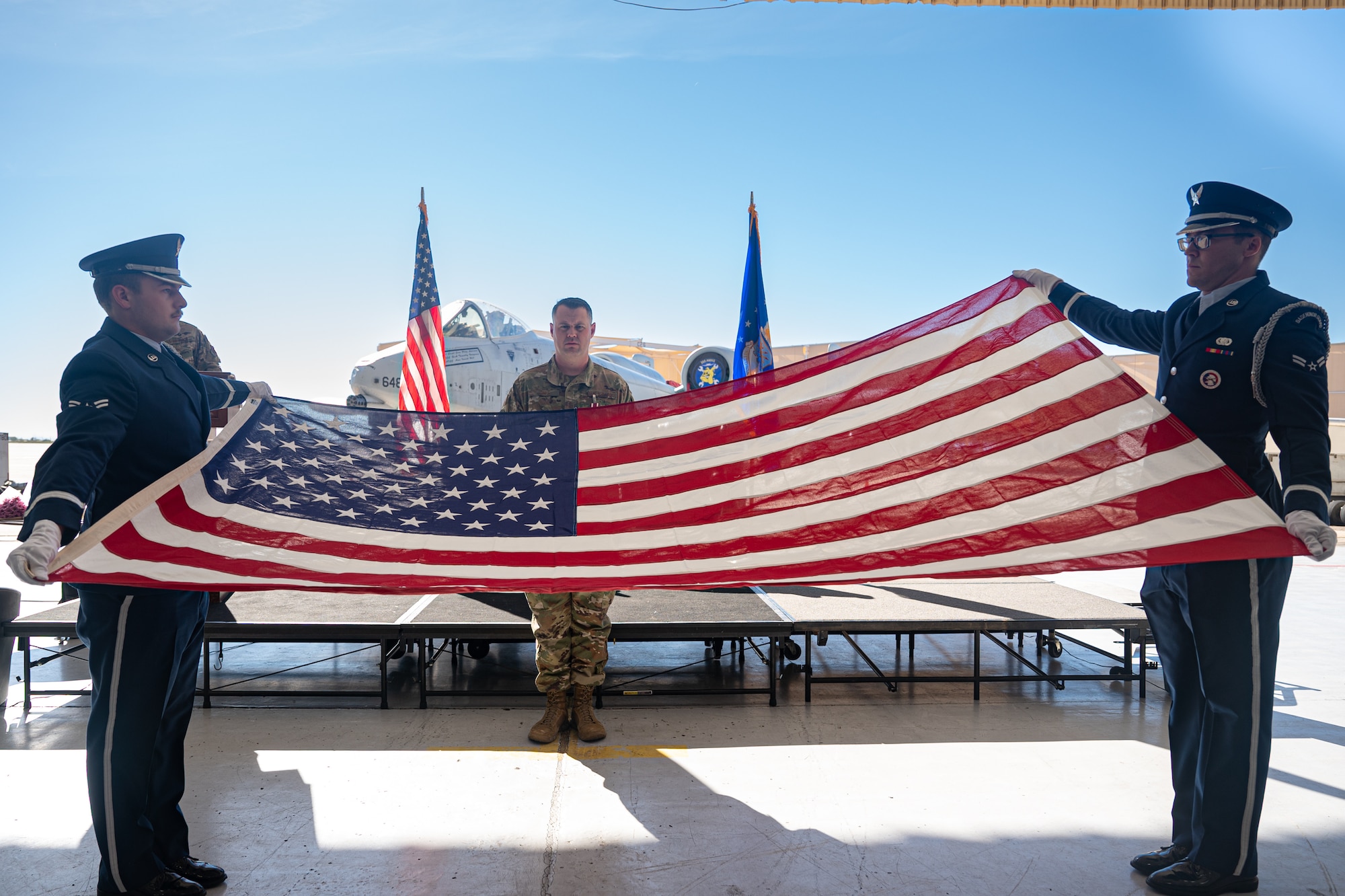Honor guard Airmen present a flag