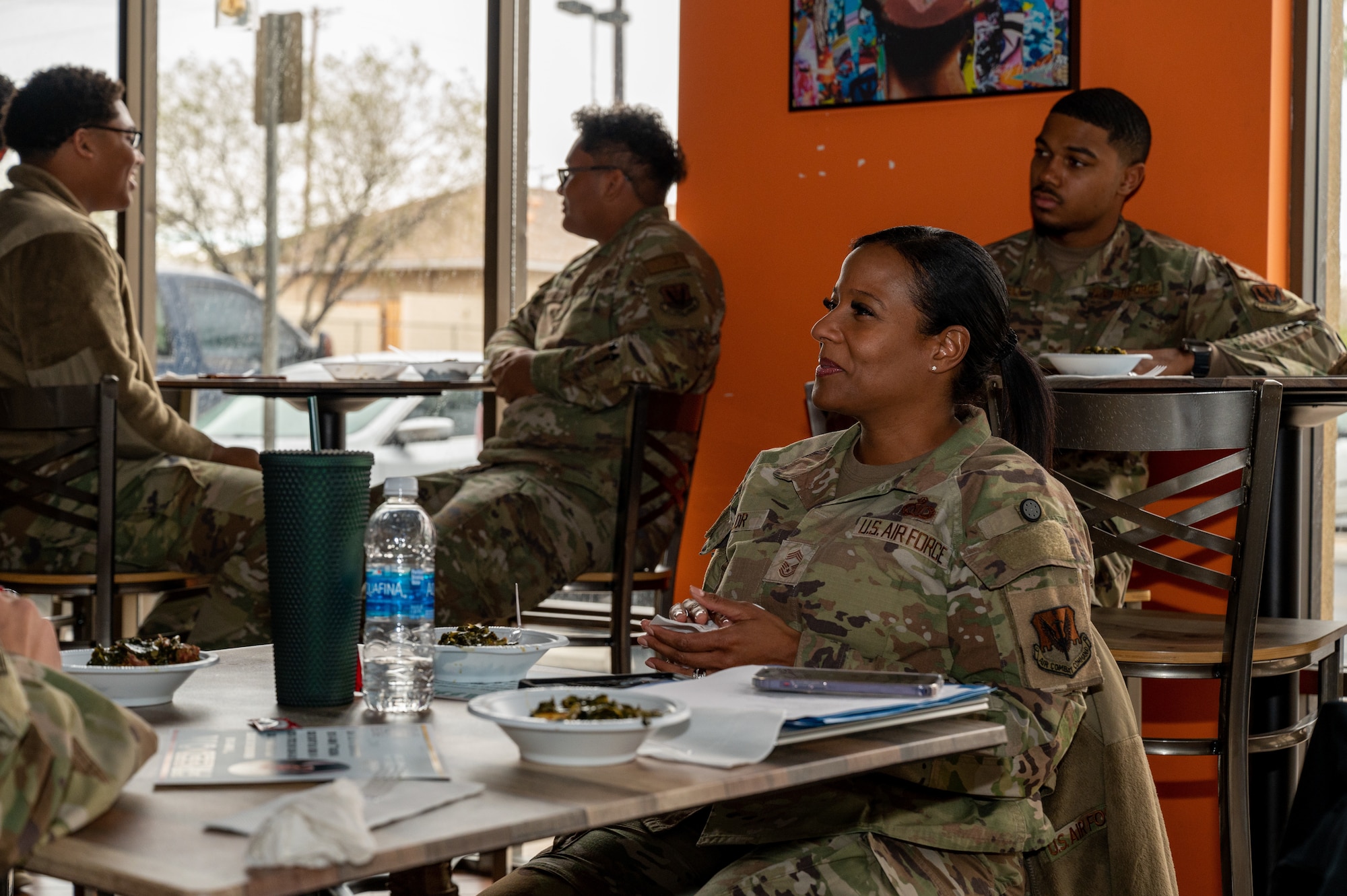 A photo of an Airman sitting at a table