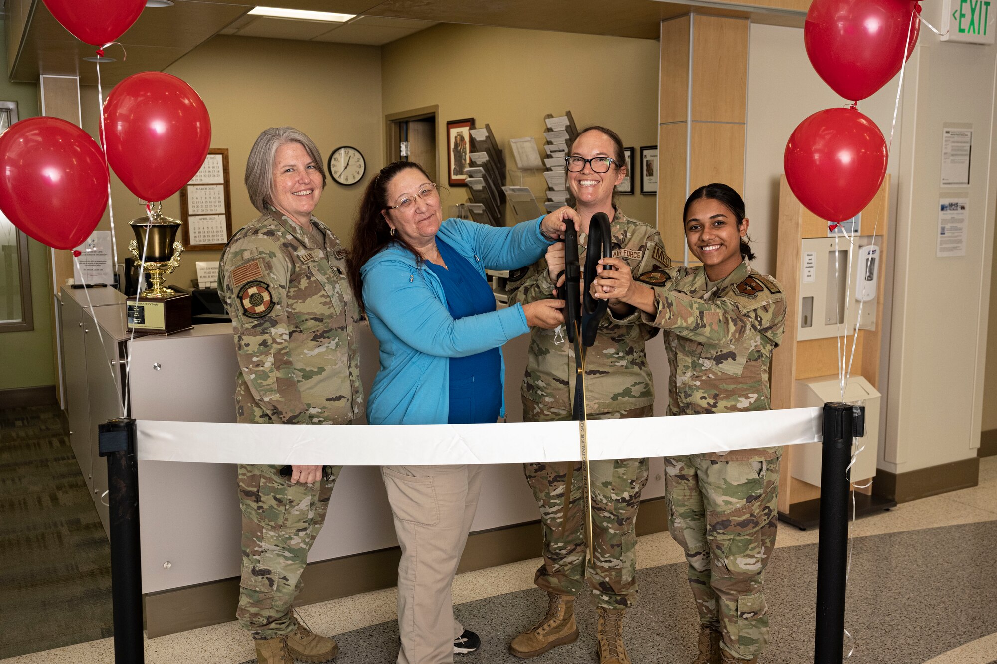 Airmen from the 49th Medical Group pose for a photo during the ribbon cutting ceremony for the Women's Health Contraceptive Clinic on Holloman Air Force Base, New Mexico, Feb. 21. 2023. This initiative to provide a structured avenue for contraceptive health is a Defense Health Agency-wide project. (U.S. Air Force photo by Senior Airman Antonio Salfran)