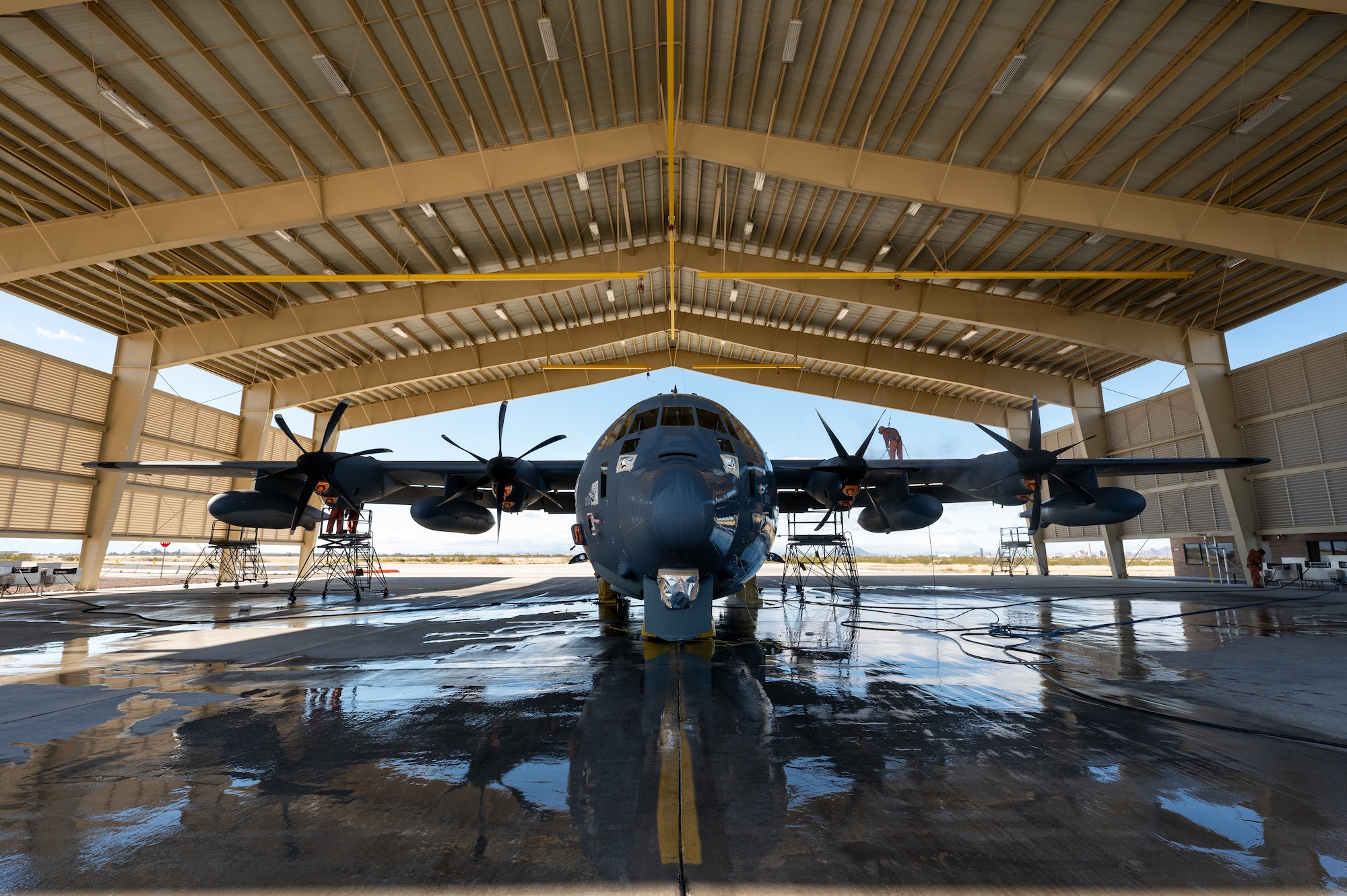 photo of a large military aircraft under a hangar