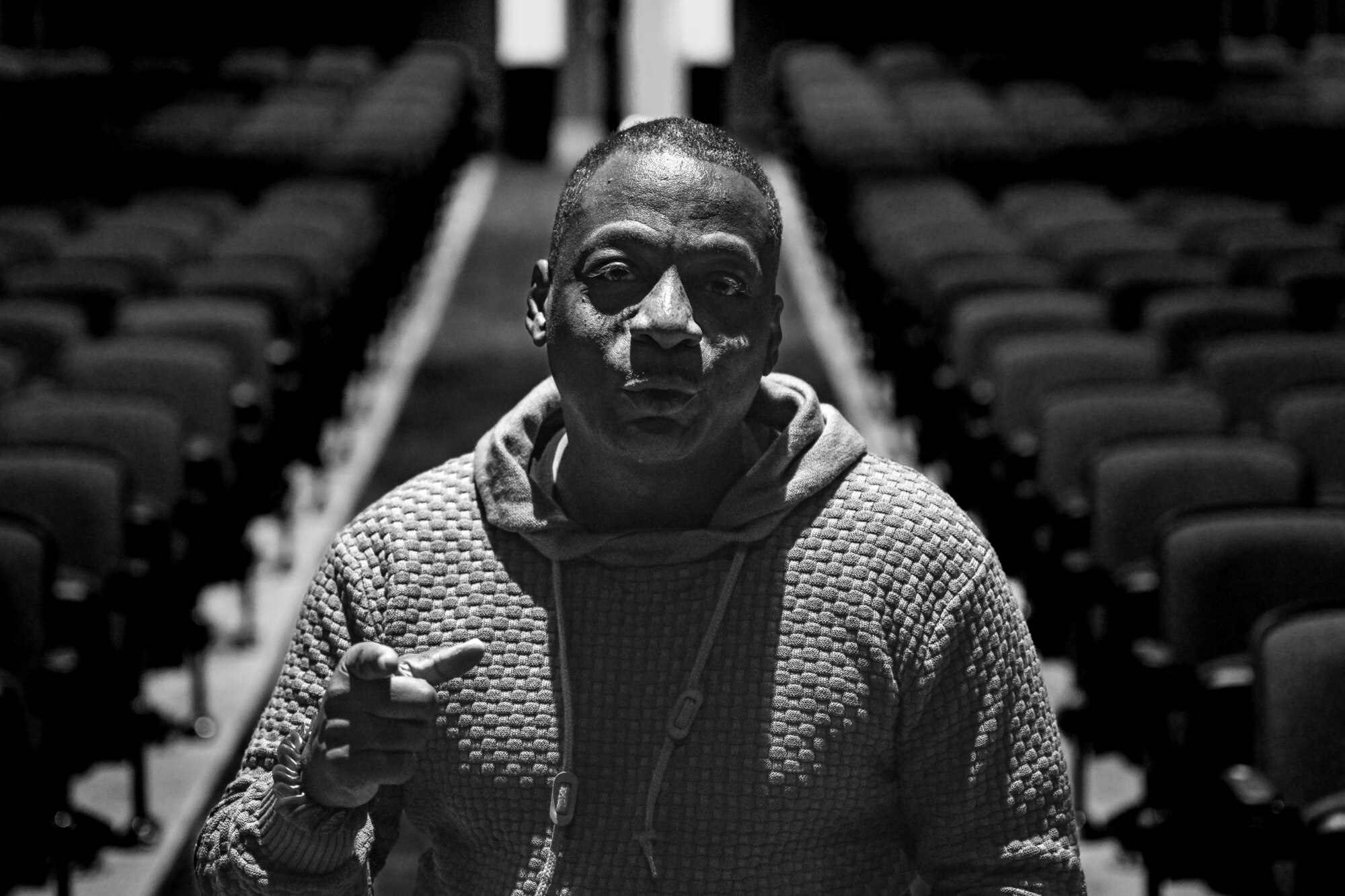man poses for a black and white photo
