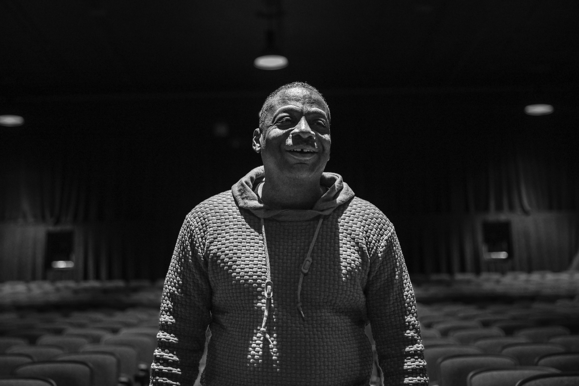 man poses for a black and white photo