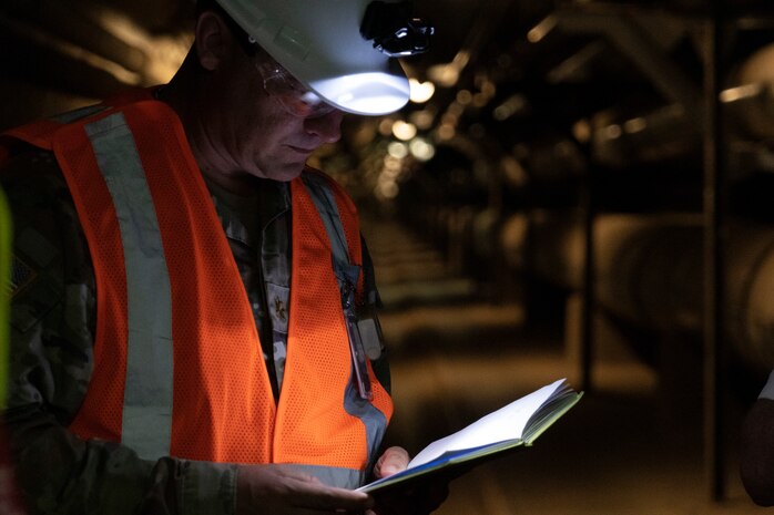 U.S. Army Maj. Stephen Buck, an engineering officer assigned to Joint Task Force-Red Hill (JTF-RH) reviews his notes inside the Red Hill Bulk Fuel Storage Facility (RHBFSF) at Halawa, Hawaii, Feb. 22, 2023. Buck is one of approximately 60 engineers working to defuel the RHBFSF. (U.S. Air National Guard photo by Staff Sgt. Orlando Corpuz)