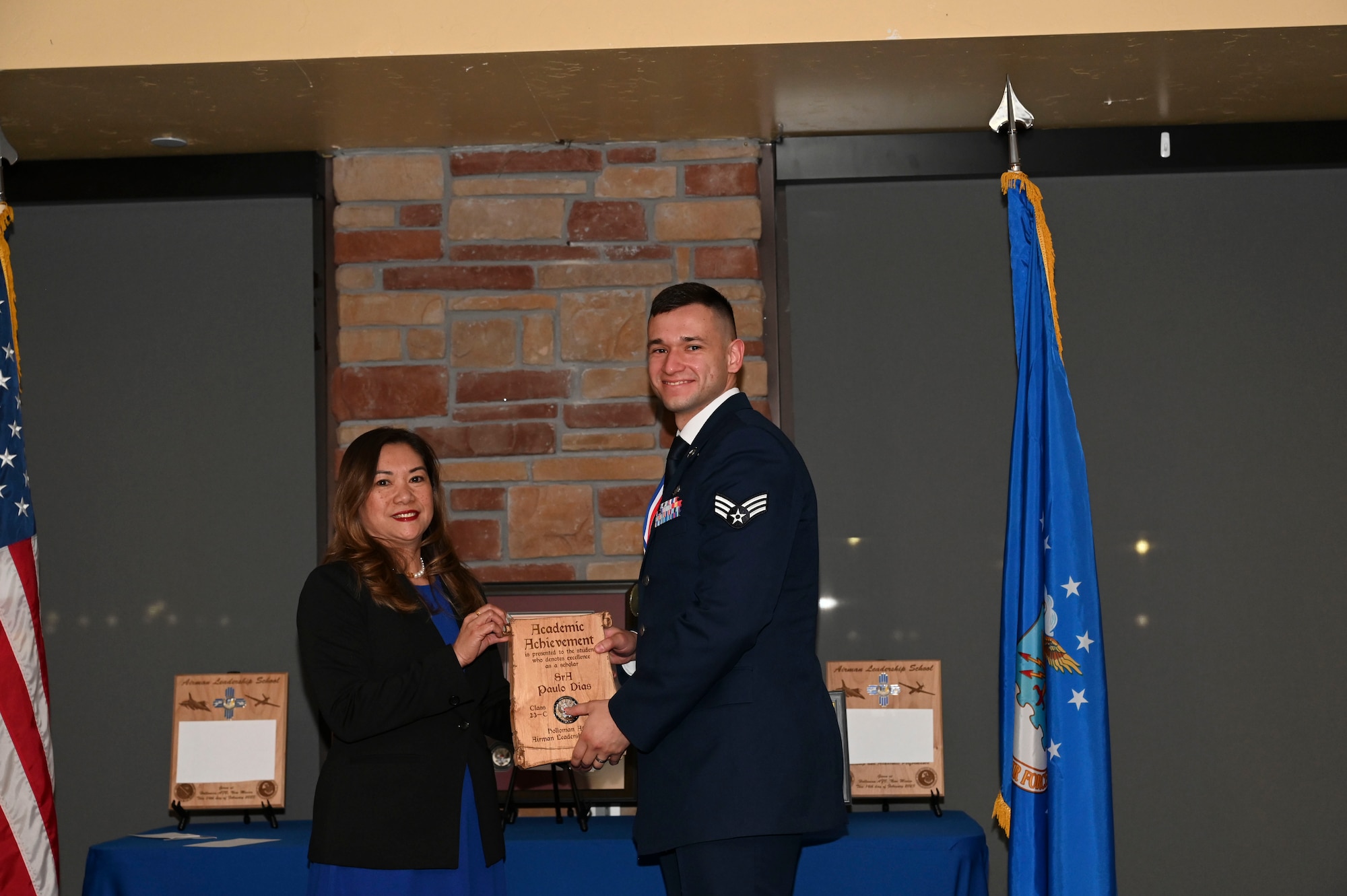 Senior Airman Paulo Dias, 49th Aircraft Maintenance Squadron, Airman Leadership School graduate, accepts the Academic Achievement Award during the graduation of ALS class 23-C at Holloman Air Force Base, New Mexico, Feb. 16, 2023. The academic award is presented to the student with the highest overall average on all academic evaluations and demonstrations of leadership. (U.S. Air Force photo by Airman 1st Class Isaiah Pedrazzini)