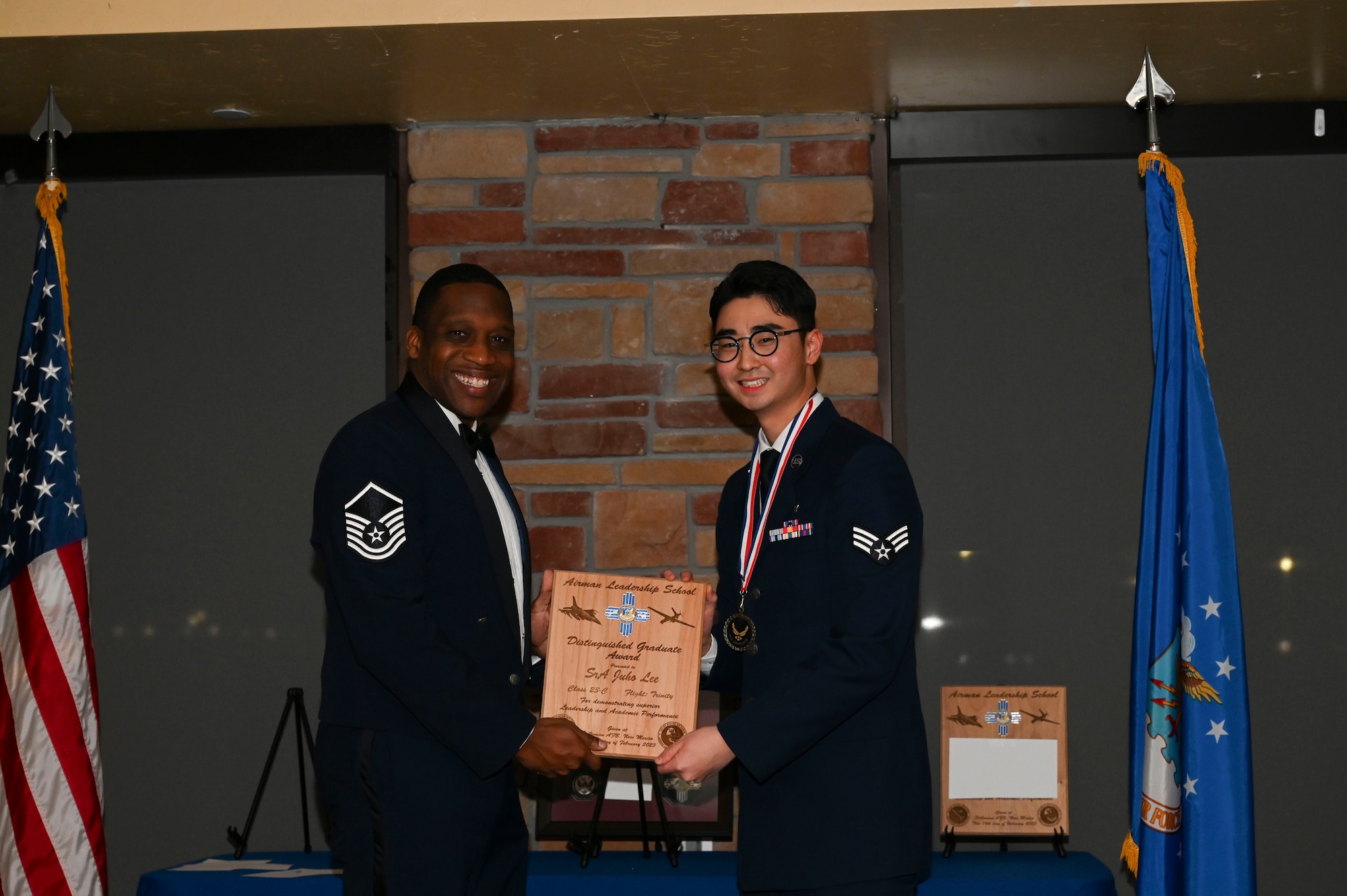 Senior Airman Juho Lee, 49th Operational Medical Readiness Squadron, Airman Leadership School graduate, accepts the distinguished graduate award during the graduation of ALS class 23-C at Holloman Air Force Base, New Mexico, Feb. 16, 2023. The distinguished graduate award is presented to the top ten percent of graduates for their performance in academic evaluations and demonstration of leadership. (U.S. Air Force photo by Airman 1st Class Isaiah Pedrazzini)