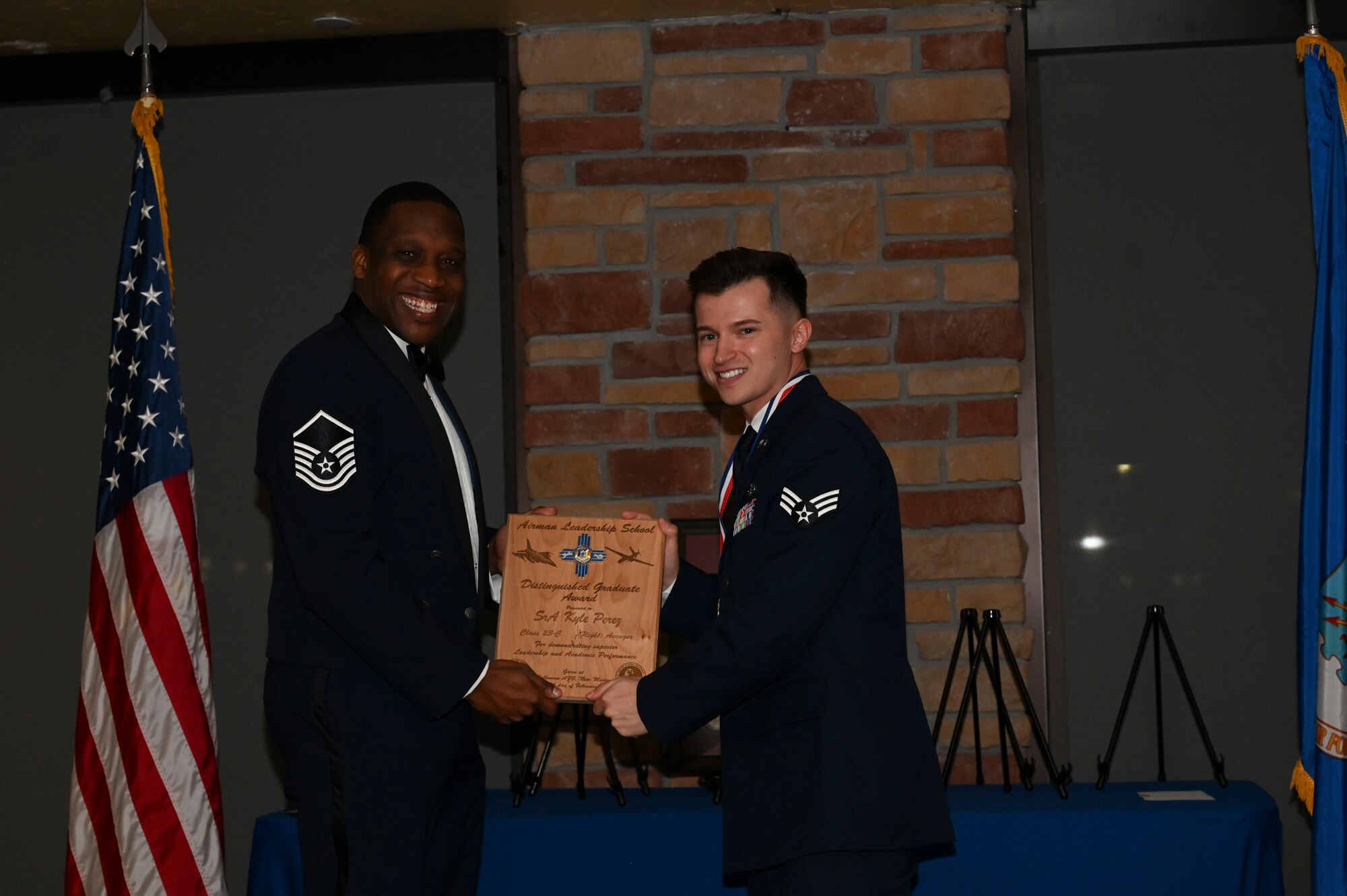 Senior Airman Kyle Perez, 49th Civil Engineer Squadron, Airman Leadership School graduate, accepts the distinguished graduate award during the graduation of ALS class 23-C at Holloman Air Force Base, New Mexico, Feb. 16, 2023. The distinguished graduate award is presented to the top ten-percent of graduates for their performance in academic evaluations and demonstration of leadership. (U.S. Air Force photo by Airman 1st Class Isaiah Pedrazzini)
