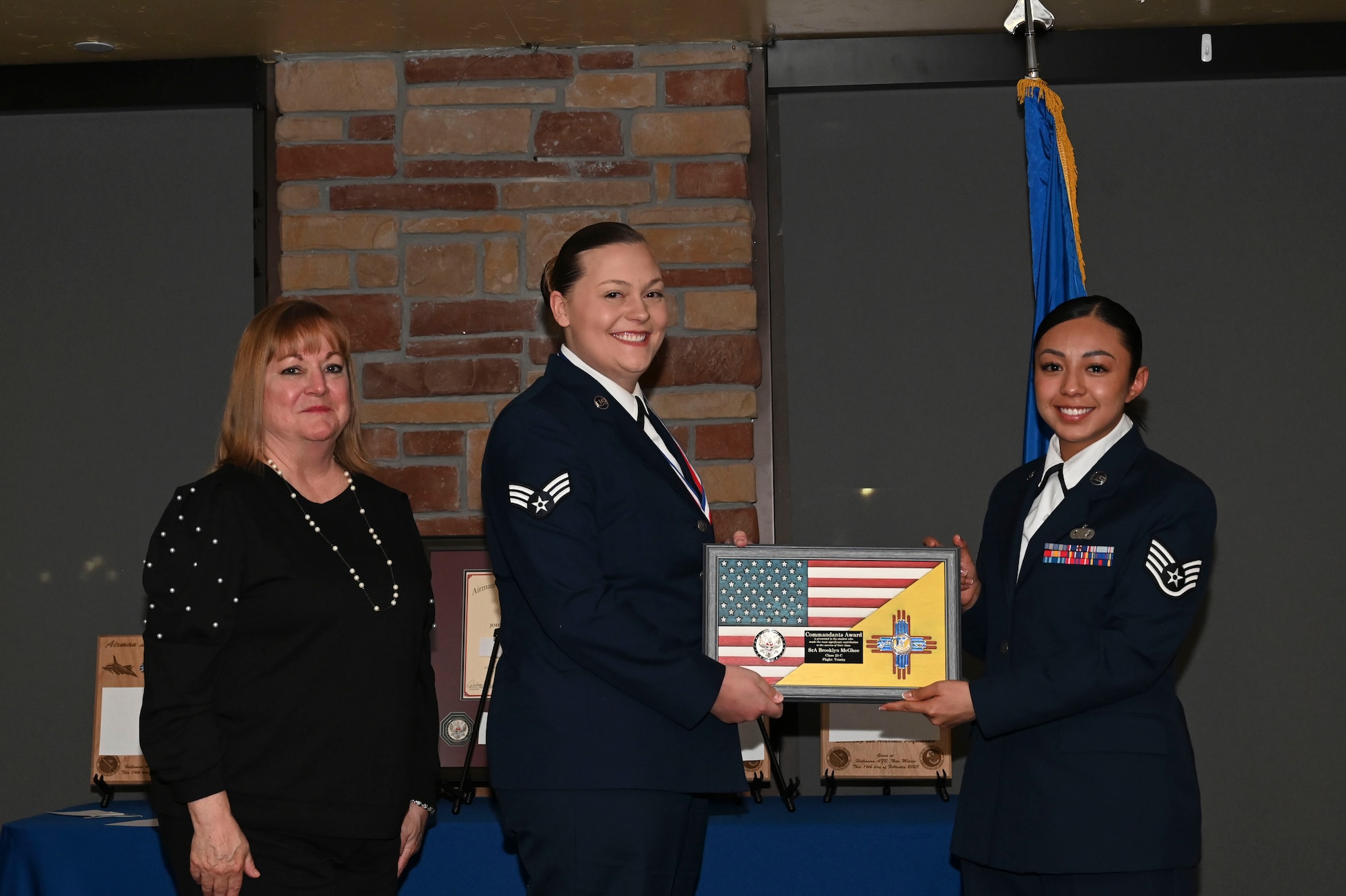 Staff Sgt. Brooklyn McGhee, 49th Component Maintenance Squadron, Airman Leadership School graduate, accepts the Commandant's Award during the graduation of ALS class 23-C at Holloman Air Force Base, New Mexico, Feb. 16, 2023. The Commandant’s award is selected by the ALS commandant and is presented to the student who best demonstrates the characteristics of an effective leader. (U.S. Air Force photo by Airman 1st Class Isaiah Pedrazzini)